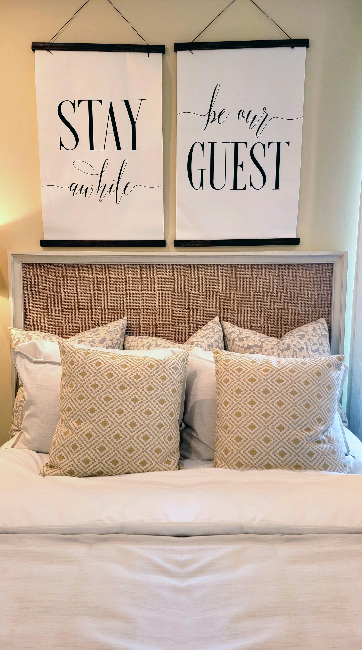 Inviting bedroom with cushions and artwork, creating a cozy atmosphere.