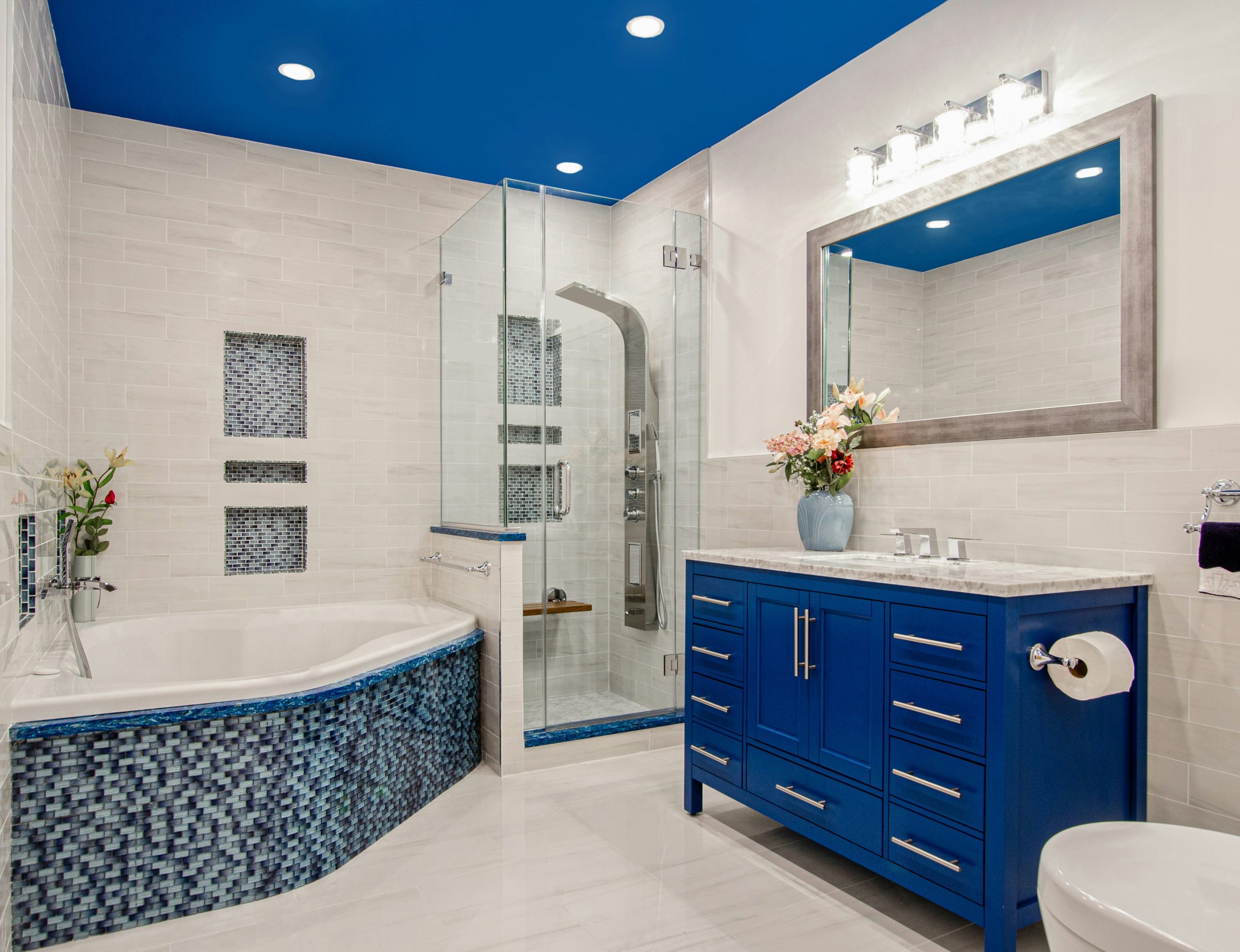 Renovated Brooklyn NY Bathroom. Blue bathroom. White Bathroom. Blue ceiling. Blue vanity. Blue tile. Jacuzzi tub. white tiles. stand up shower. 