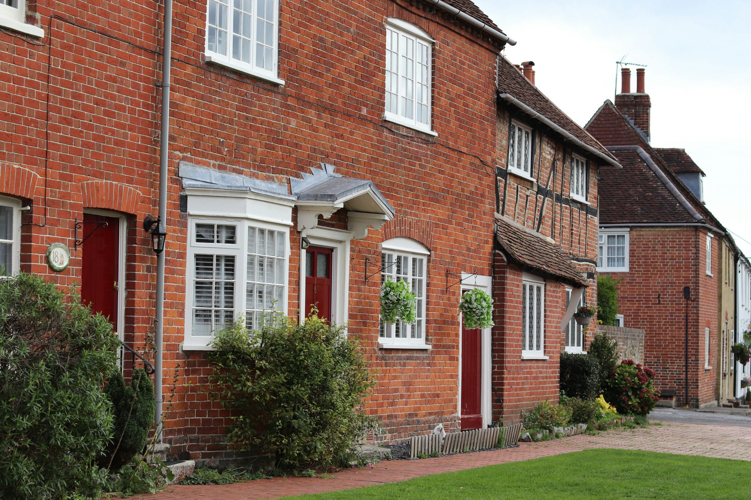 Row of traditional brick houses with red doors