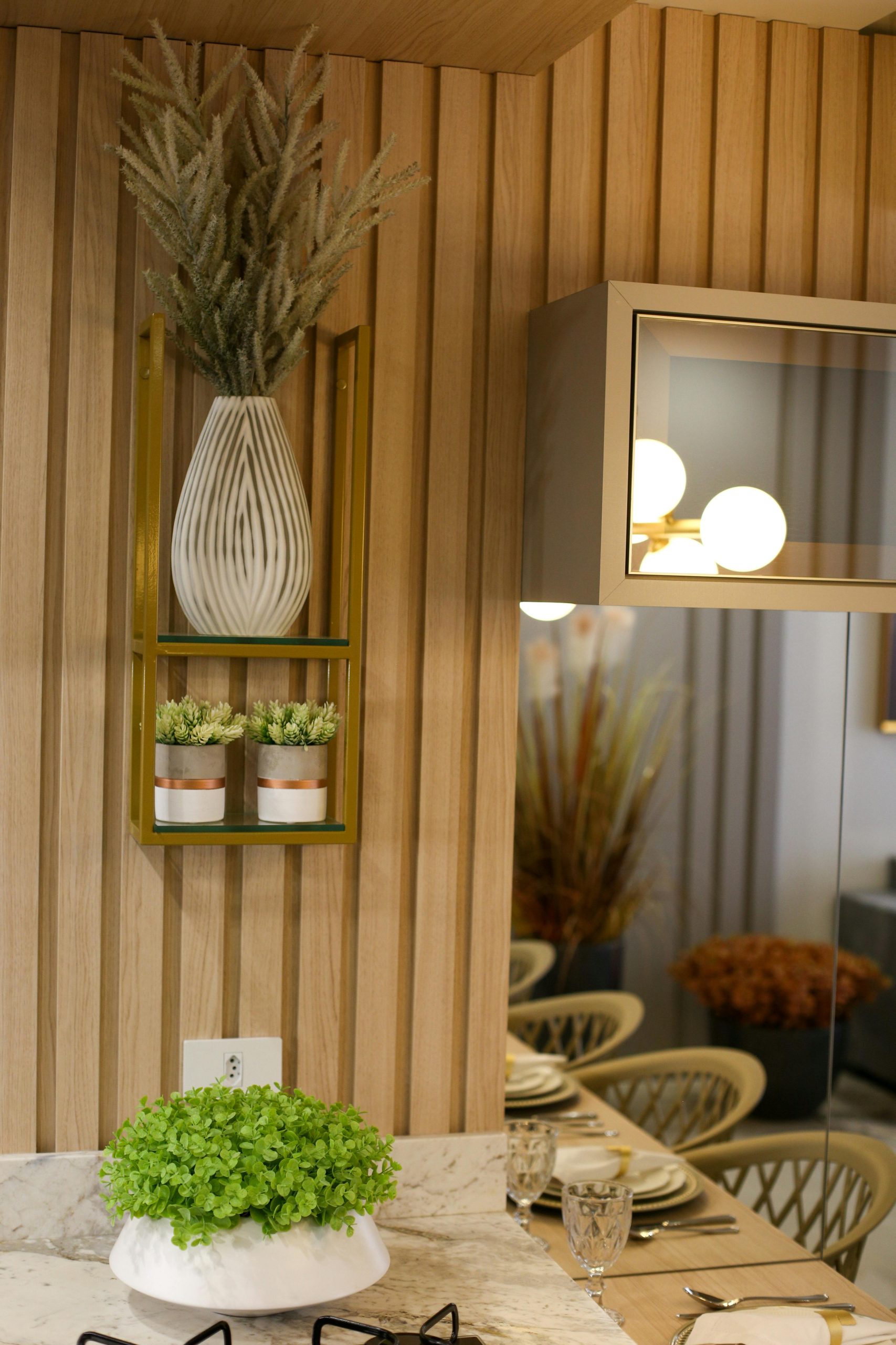 Stylish kitchen interior featuring decorative vases and plants on a wood backdrop.