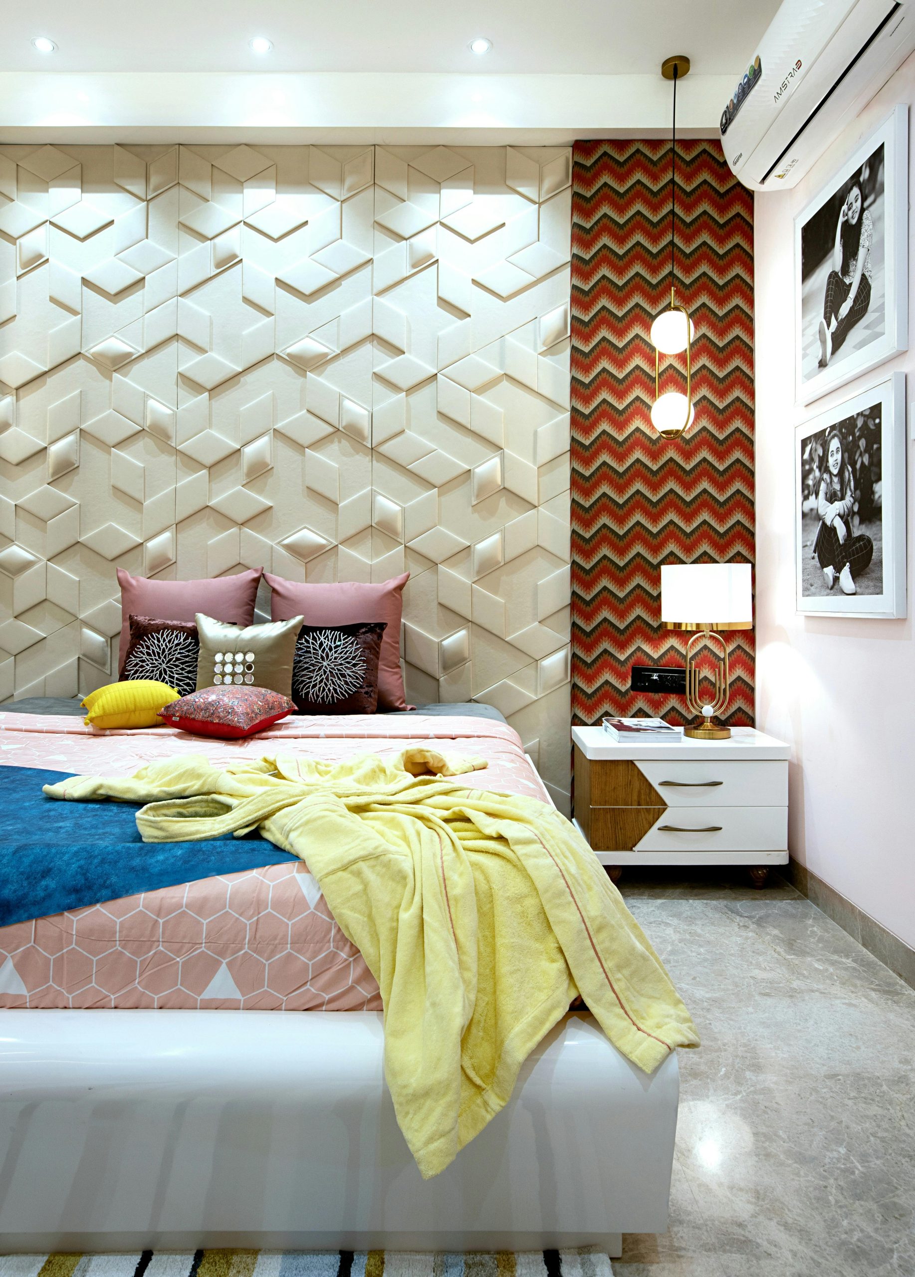 Stylish modern bedroom featuring a geometric accent wall design and vibrant decor elements.