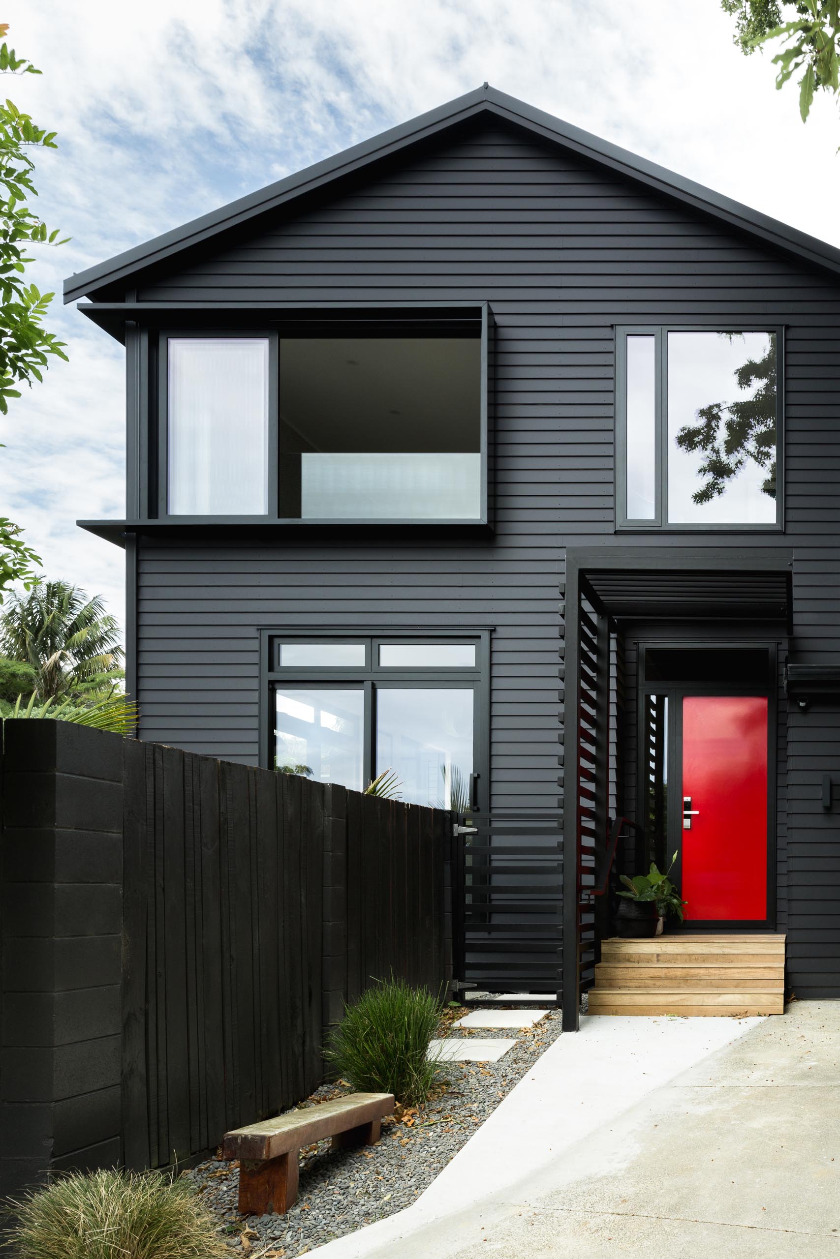 The Black Exterior Of This Home With A Bold Red Front Door Hides A Light Interior Palette