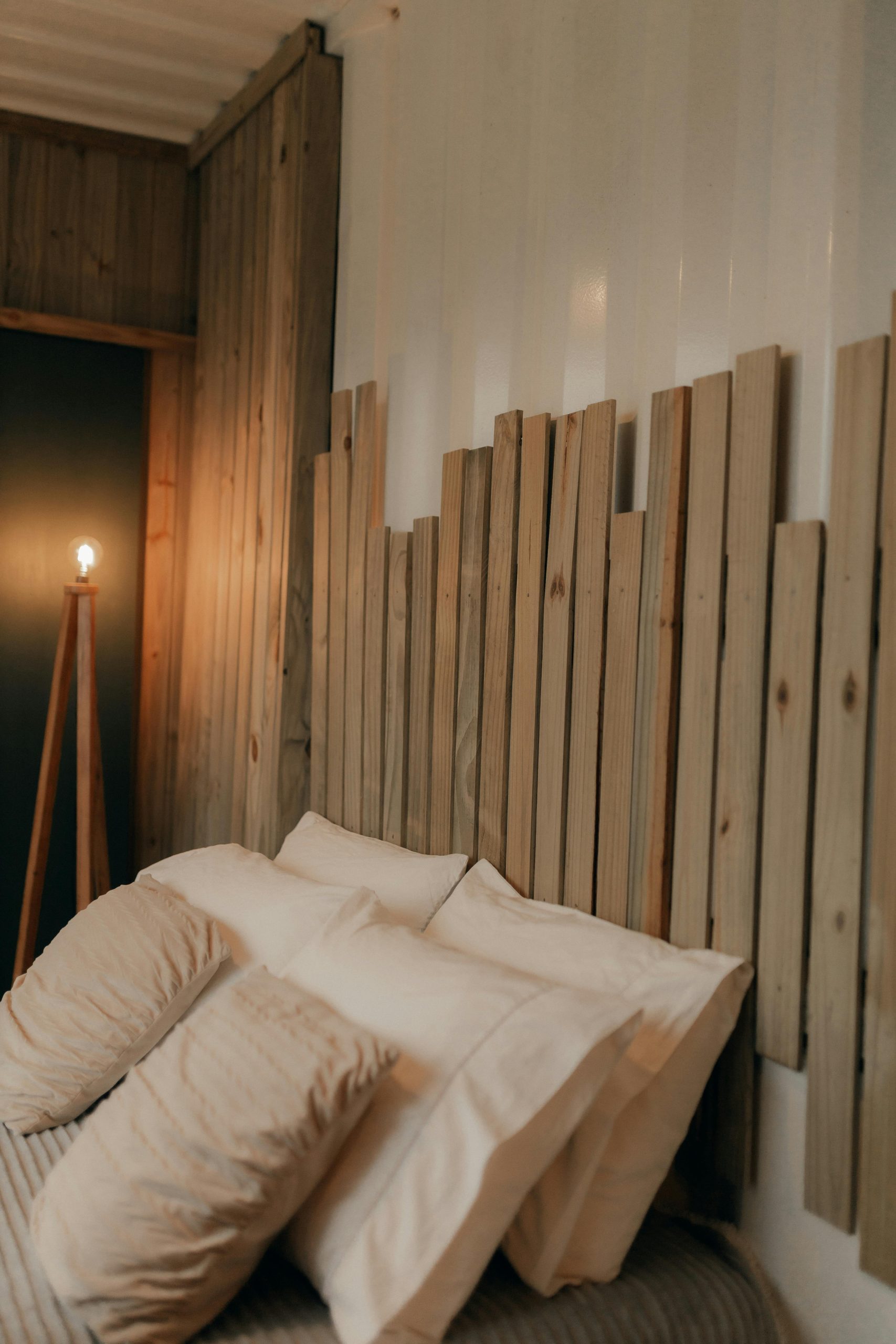 Warm, rustic bedroom interior with wooden headboard and soft ambient lighting.