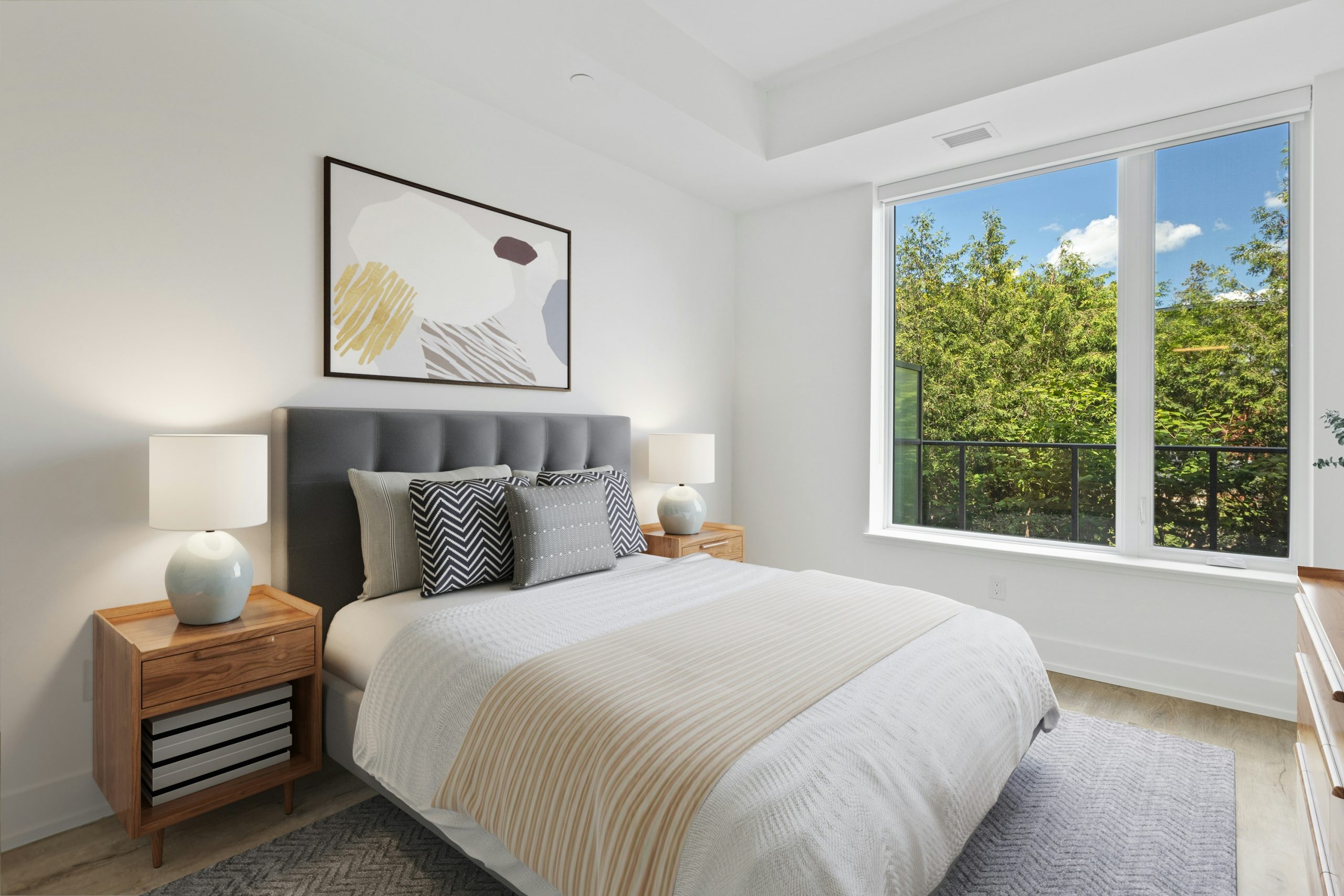 white bed with white and black throw pillows
