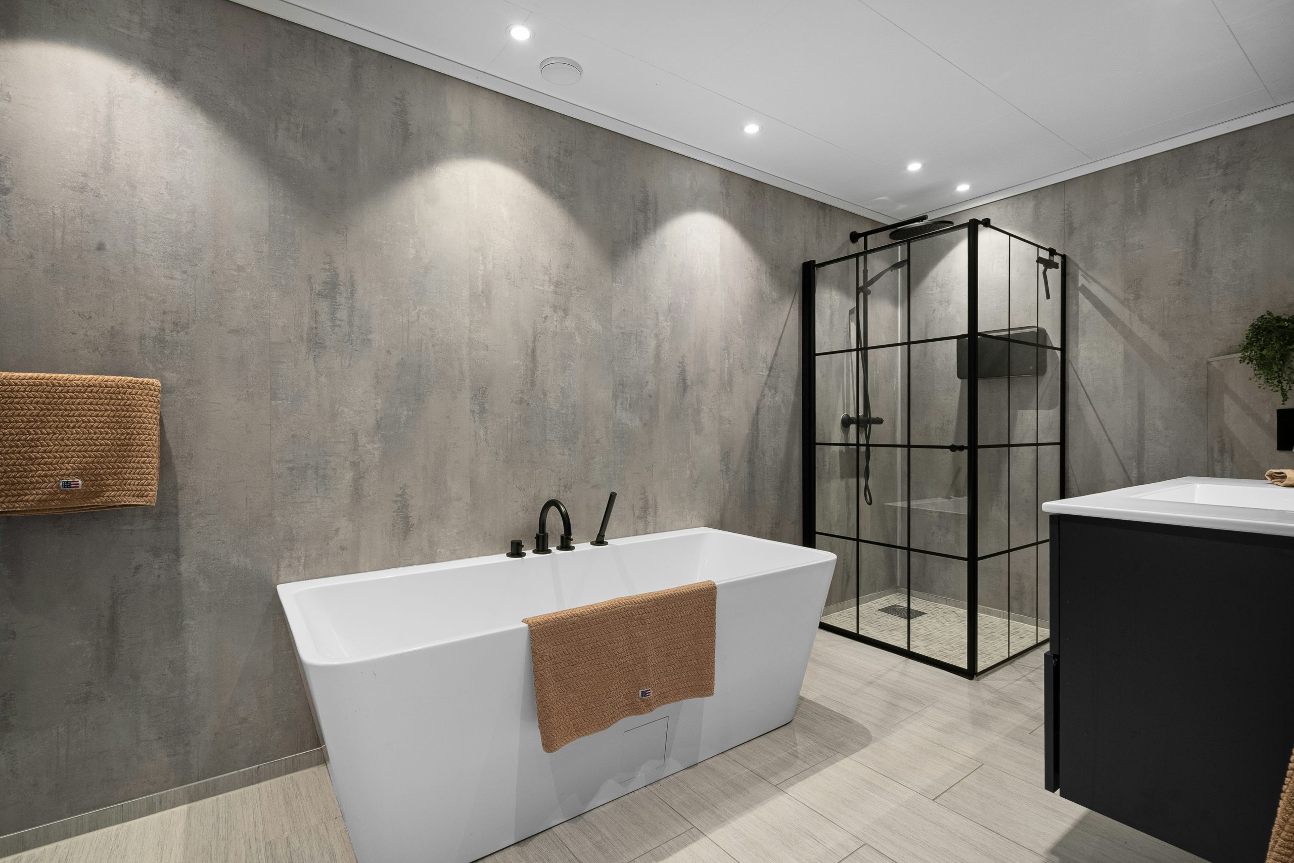 A bathroom with a large bathtub and a sink