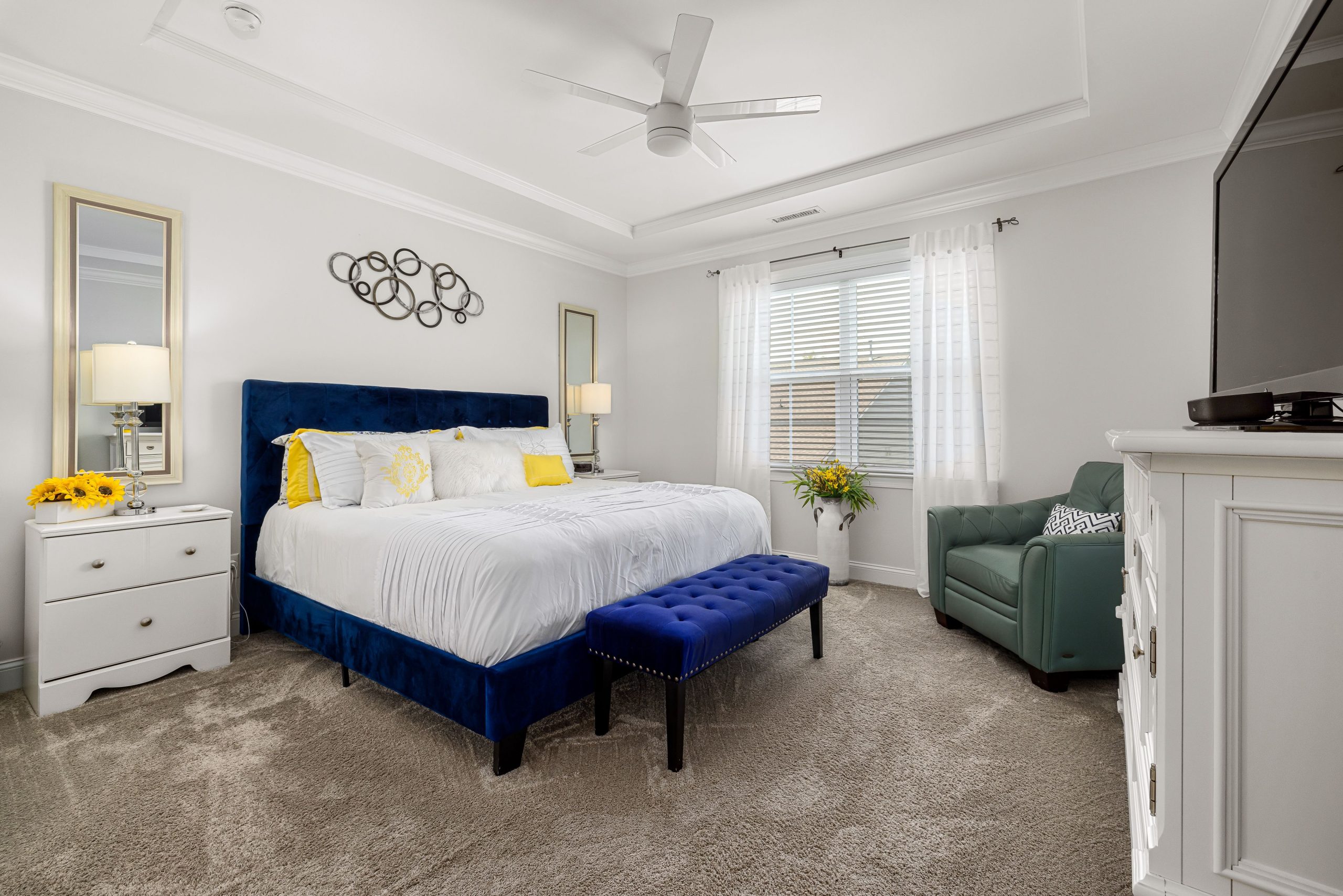 A beautifully designed modern bedroom with white and blue decor elements, perfect for a serene ambiance.