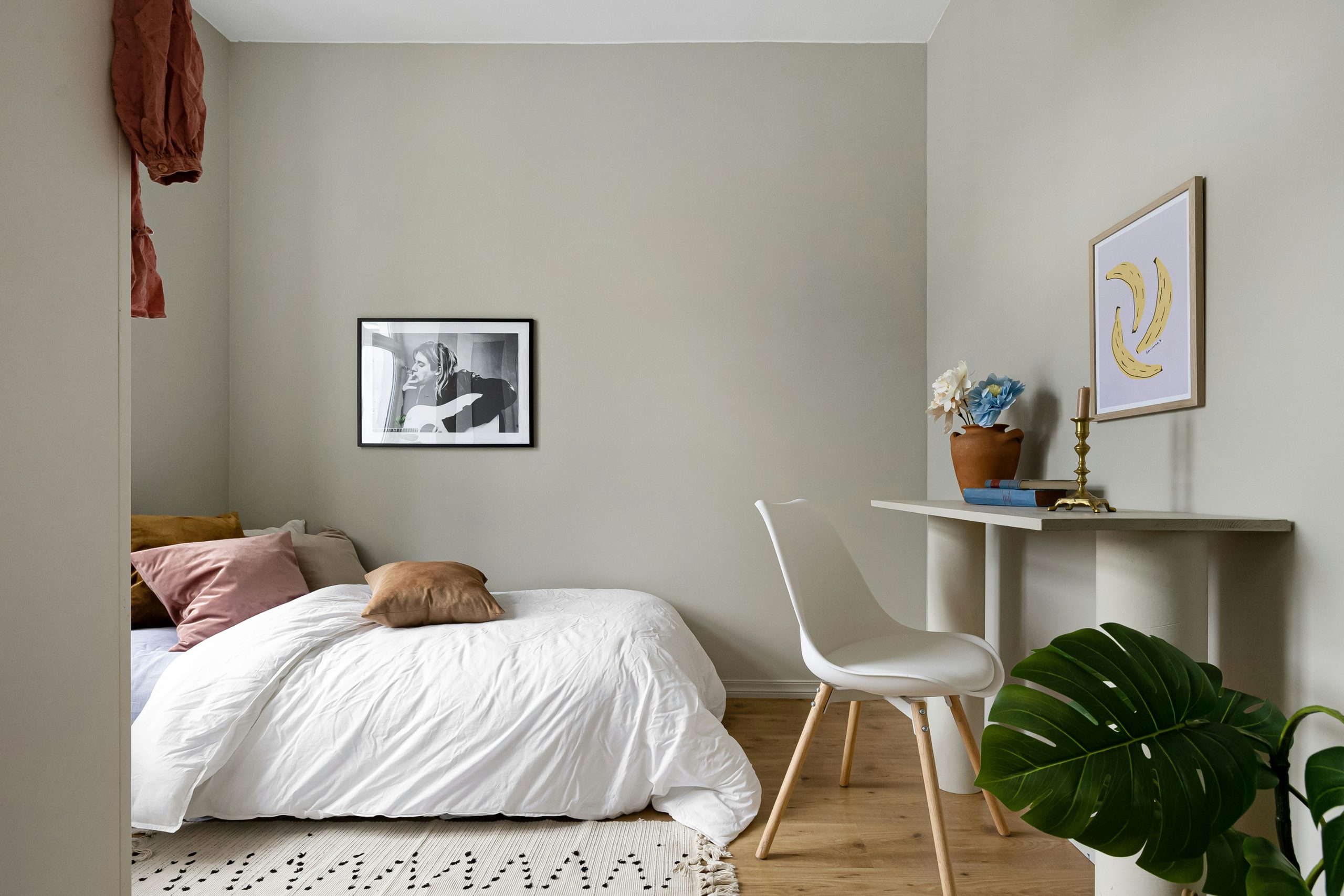 A bedroom with a bed and a desk