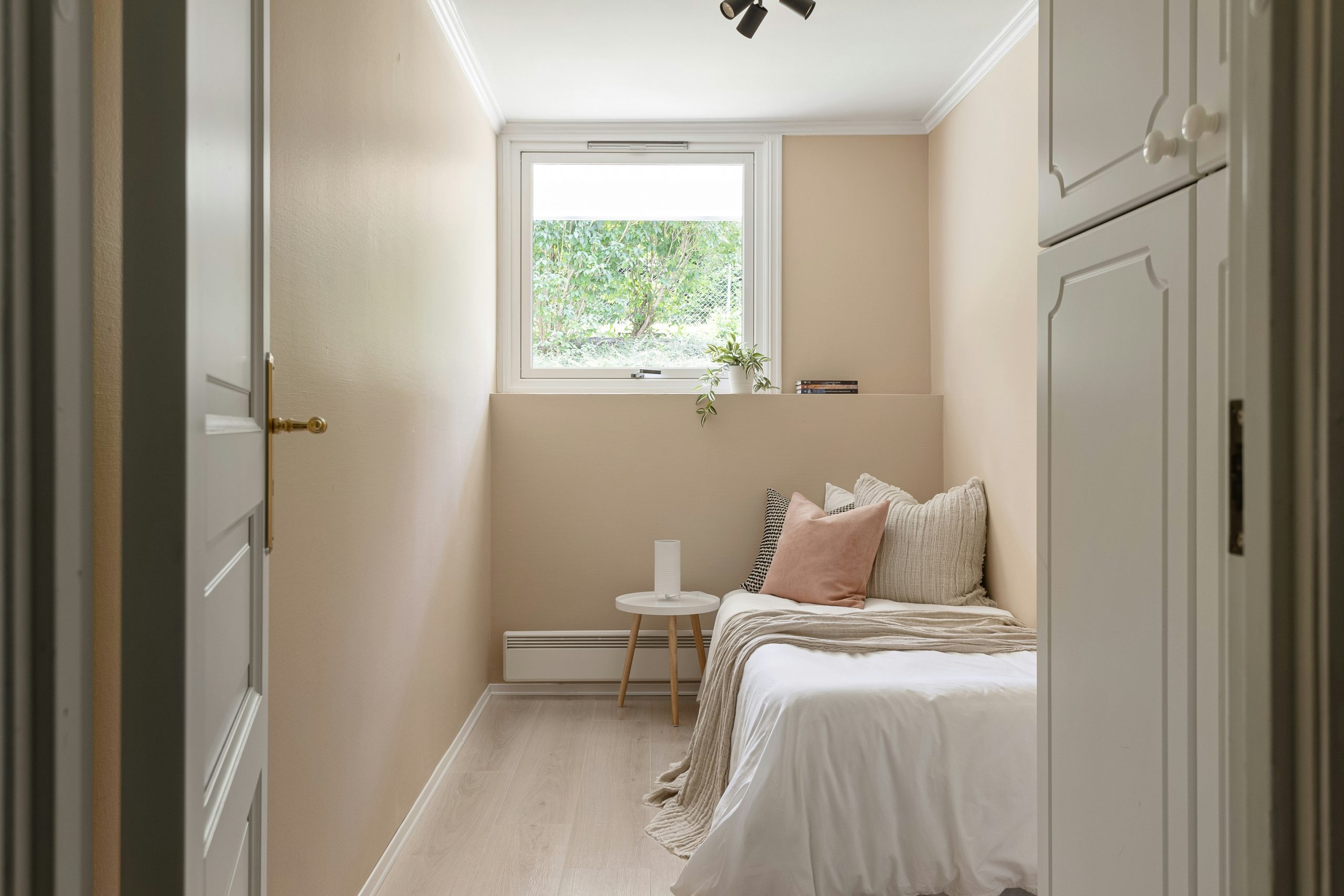 A bedroom with a bed and a window