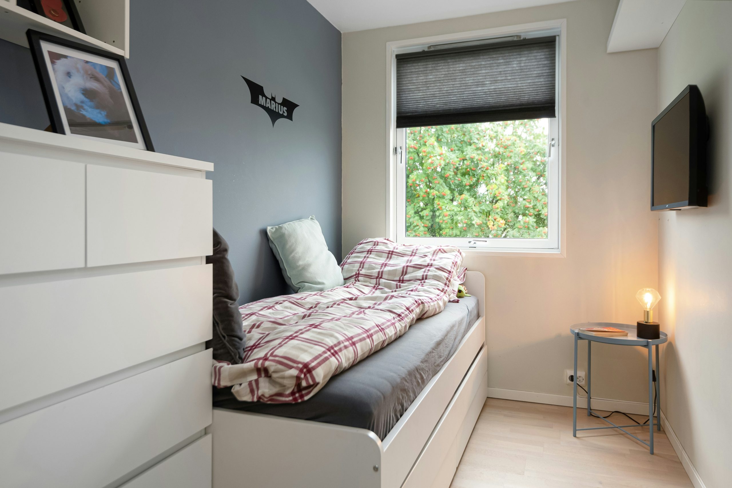 A bedroom with a bed and a window