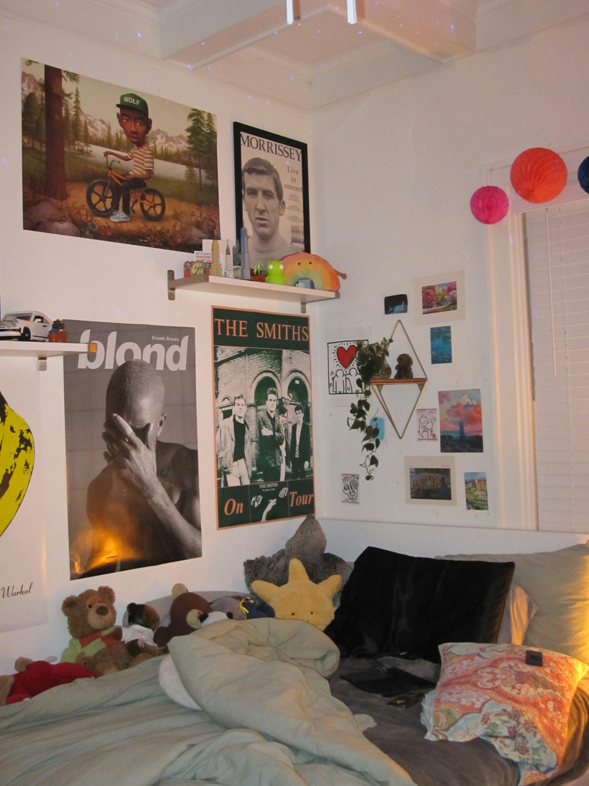 A bedroom with a lot of pictures on the wall