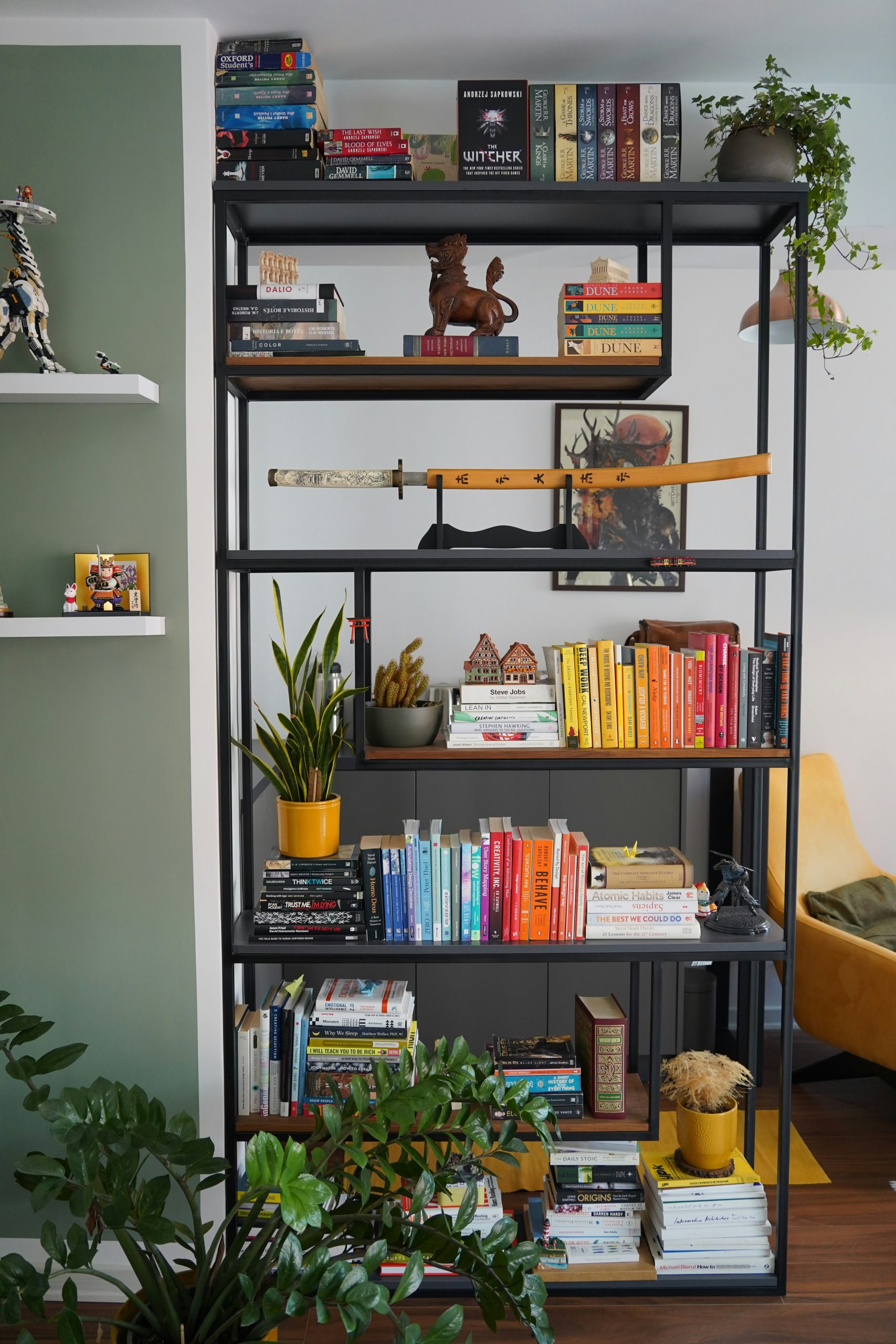 a bookshelf filled with lots of books next to a yellow chair
