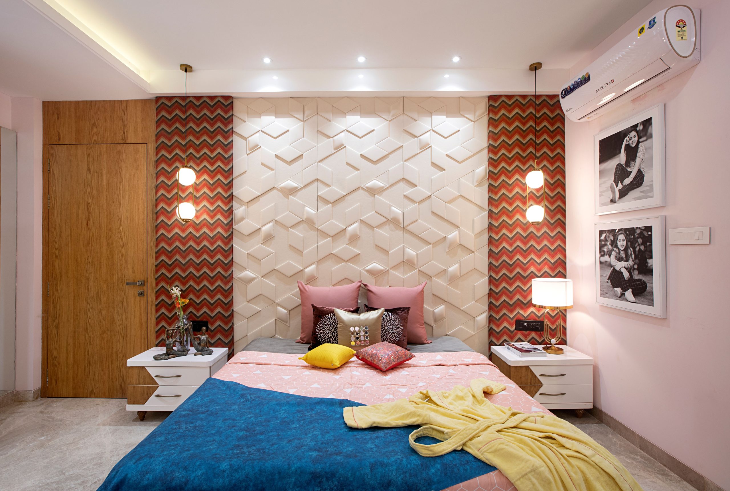 A cozy, stylish bedroom featuring geometric wall panels and modern decor with vibrant accents.