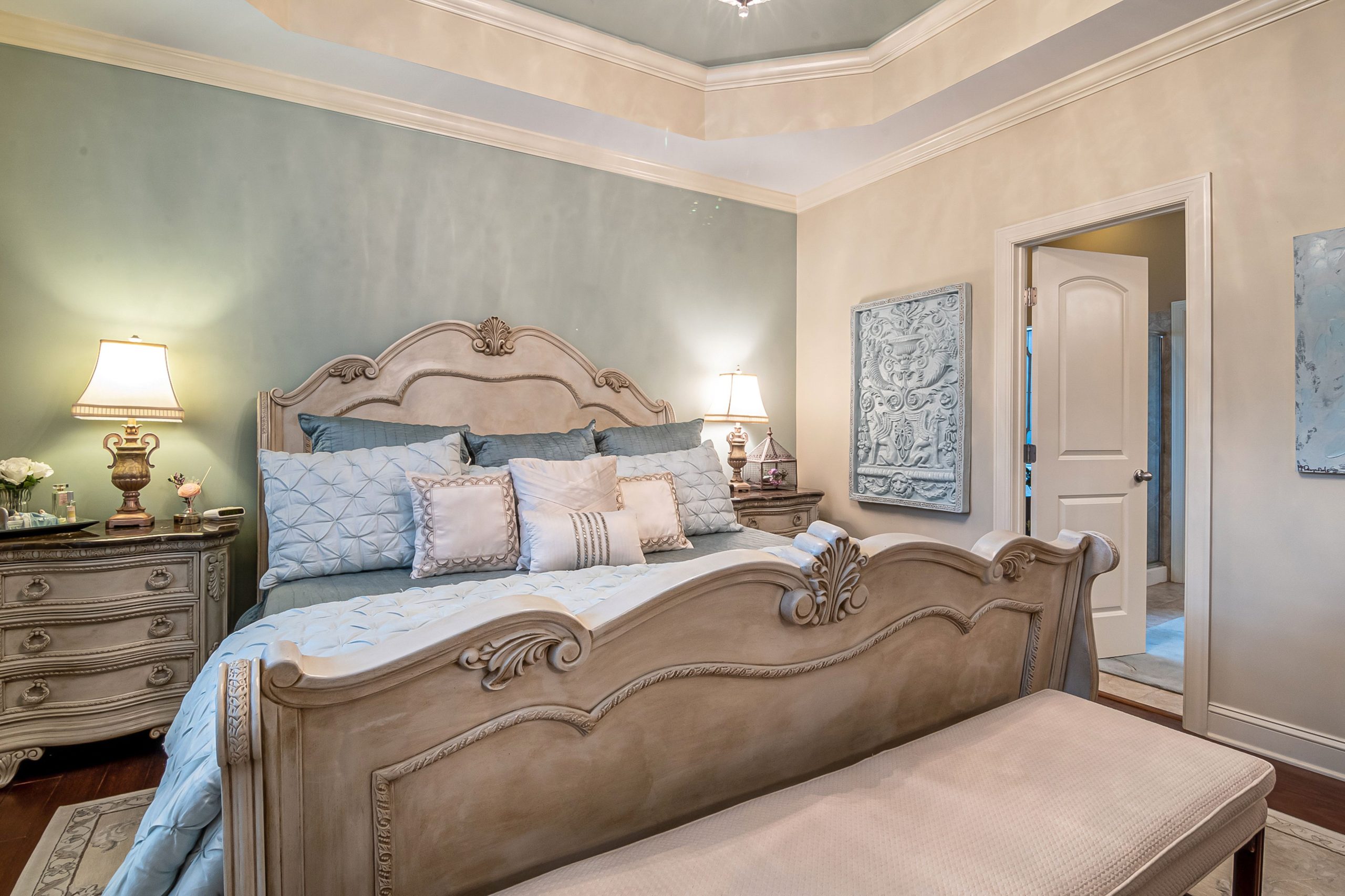 A lavishly decorated bedroom featuring classic furniture, soft lighting, and elegant decor.