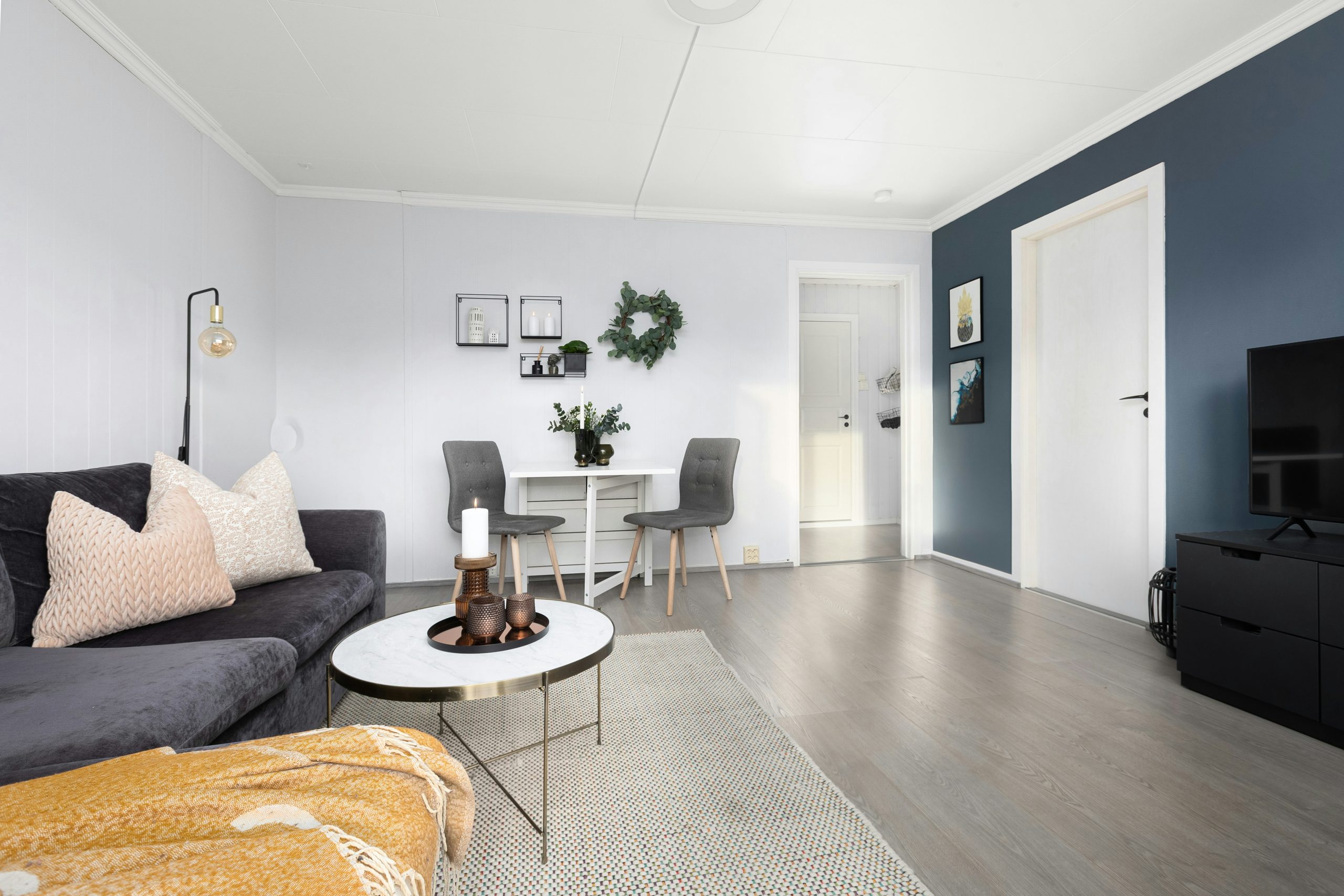 A living room filled with furniture and a flat screen TV