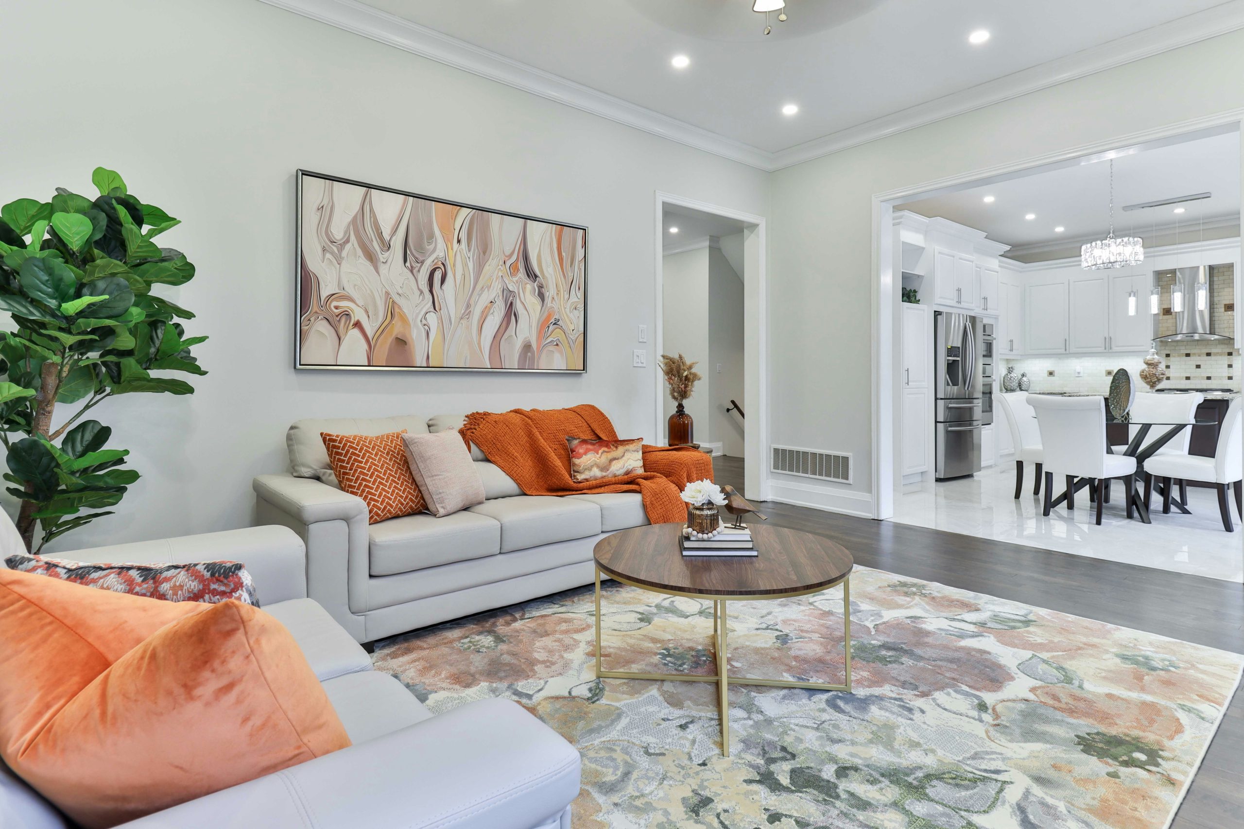 a living room filled with furniture and a painting on the wall