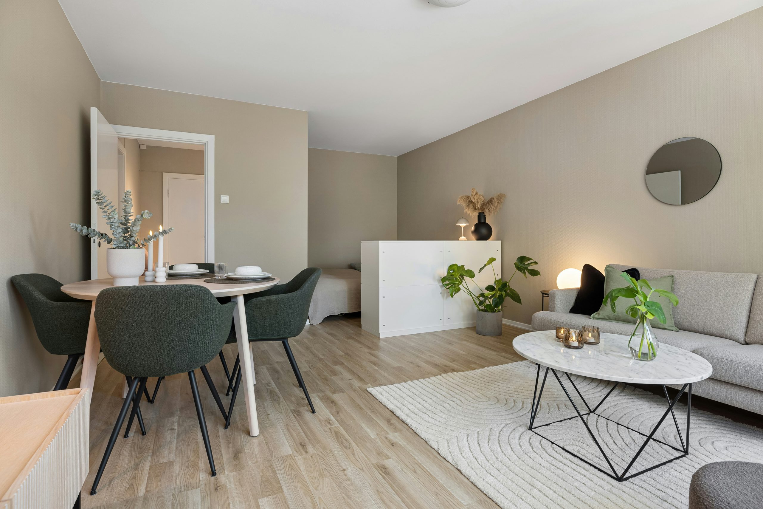 A living room filled with furniture and a dining room table