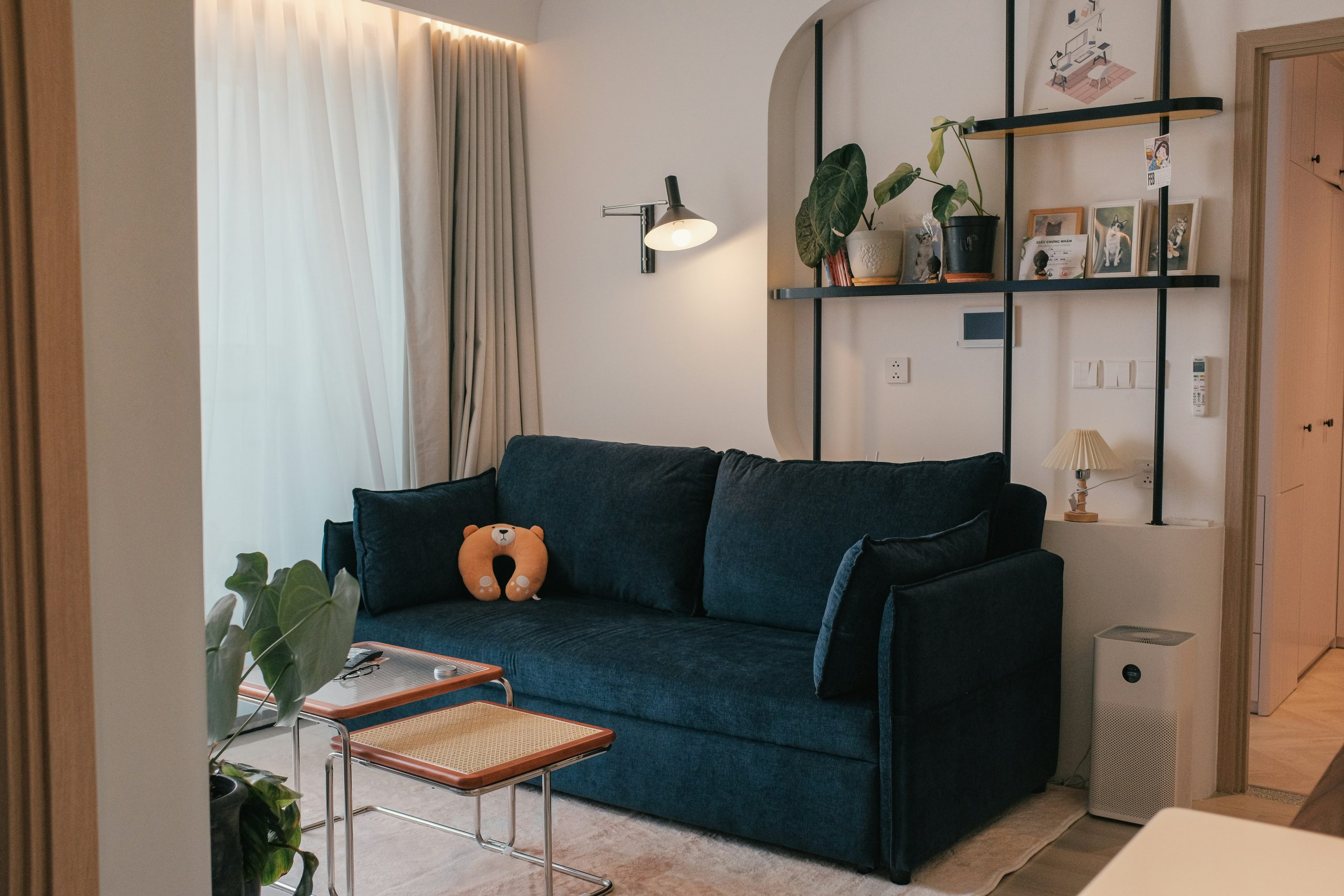 A living room with a blue couch and a coffee table