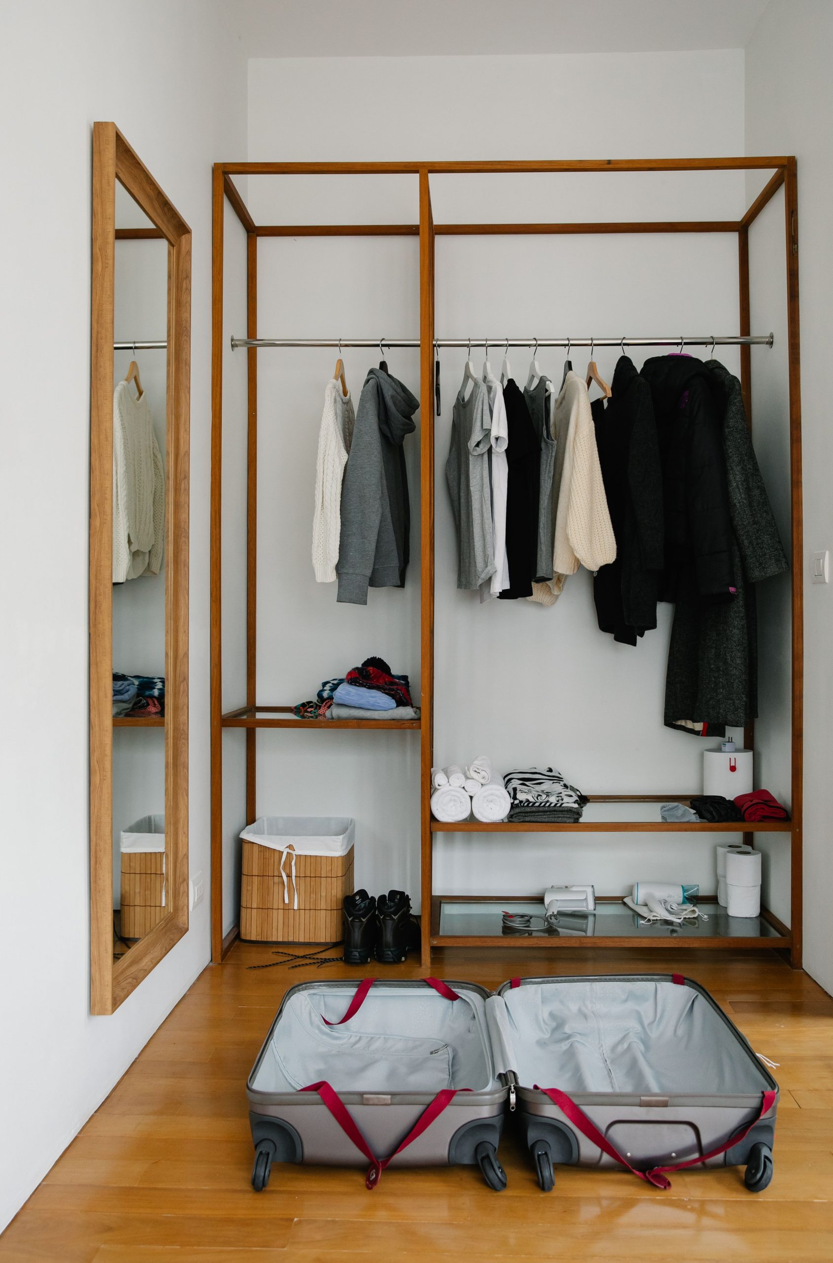 A minimal wardrobe with an open suitcase ready for packing, perfect for travel preparation visuals.