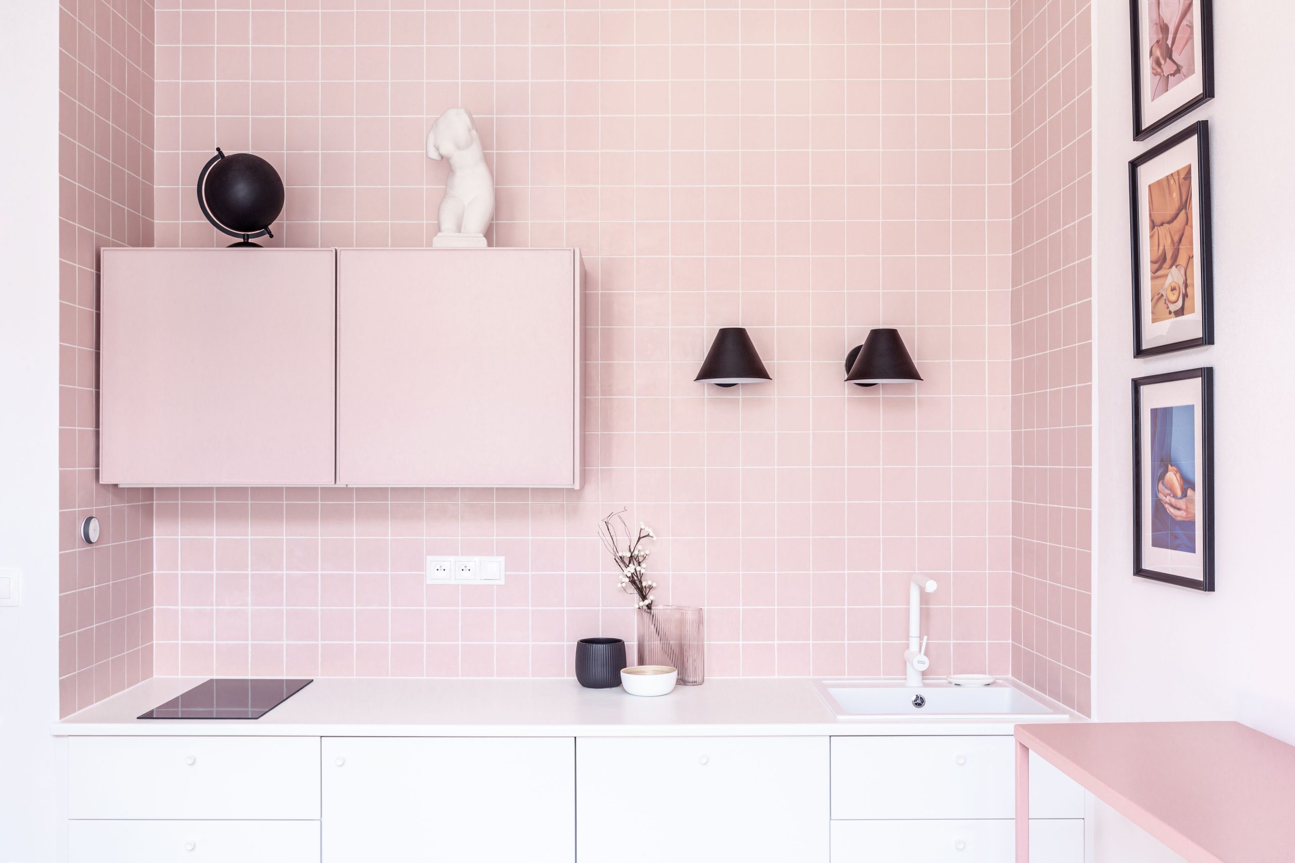 A sleek and stylish pink-themed kitchen interior with minimalist design elements in Prague.