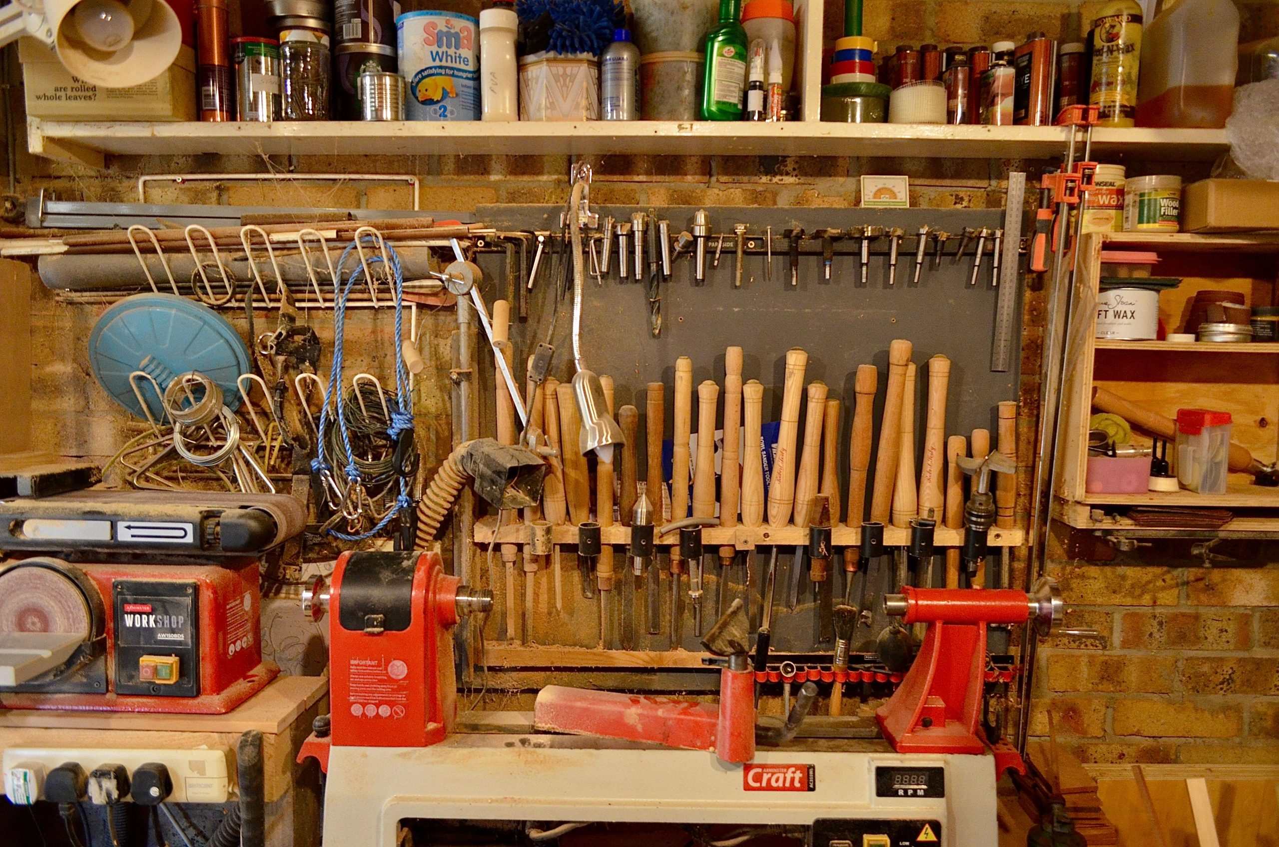 A well-organized woodworking workshop with various tools and equipment neatly arranged.