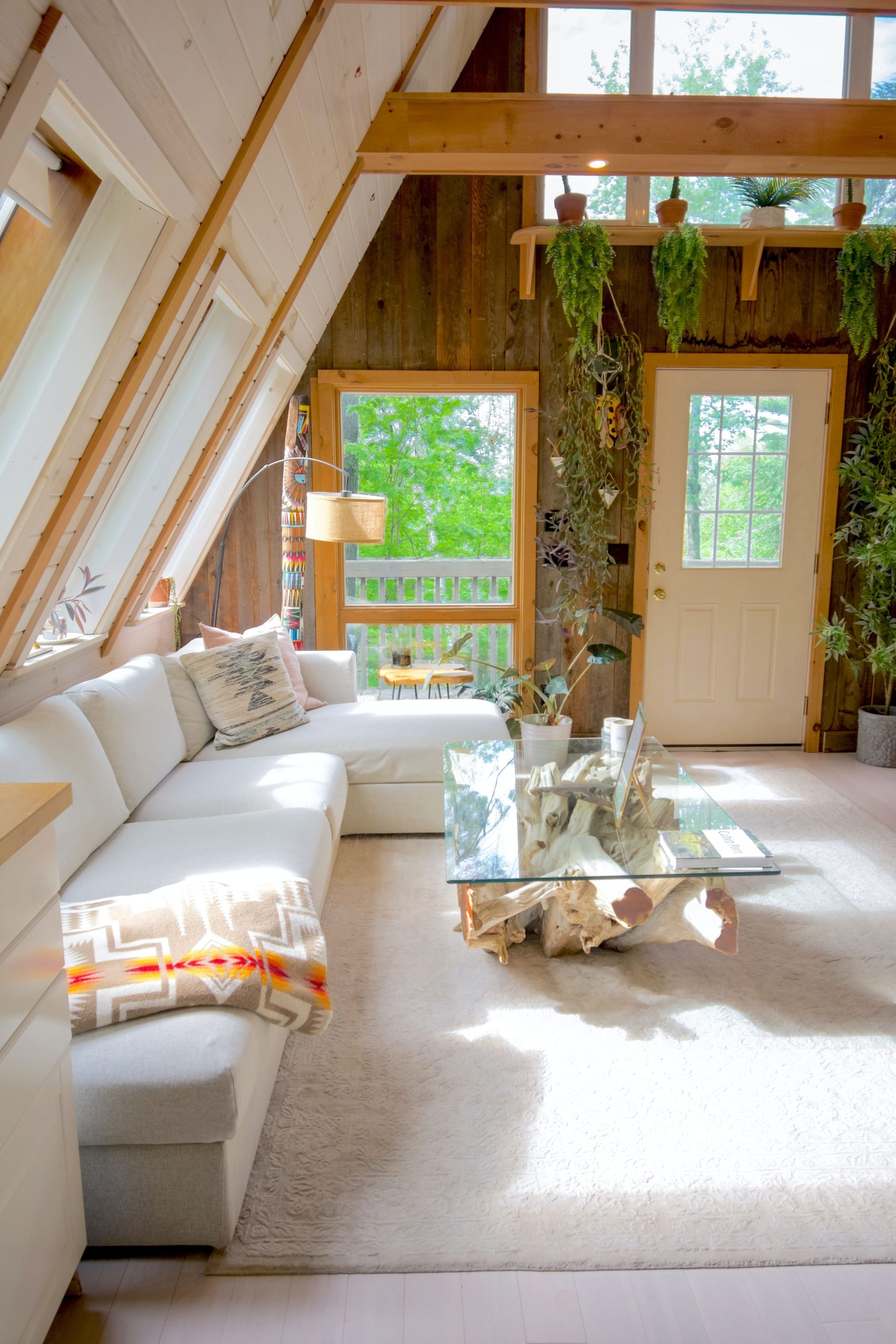 Bright and airy A-frame cabin living room with modern decor in Stowe, Vermont.