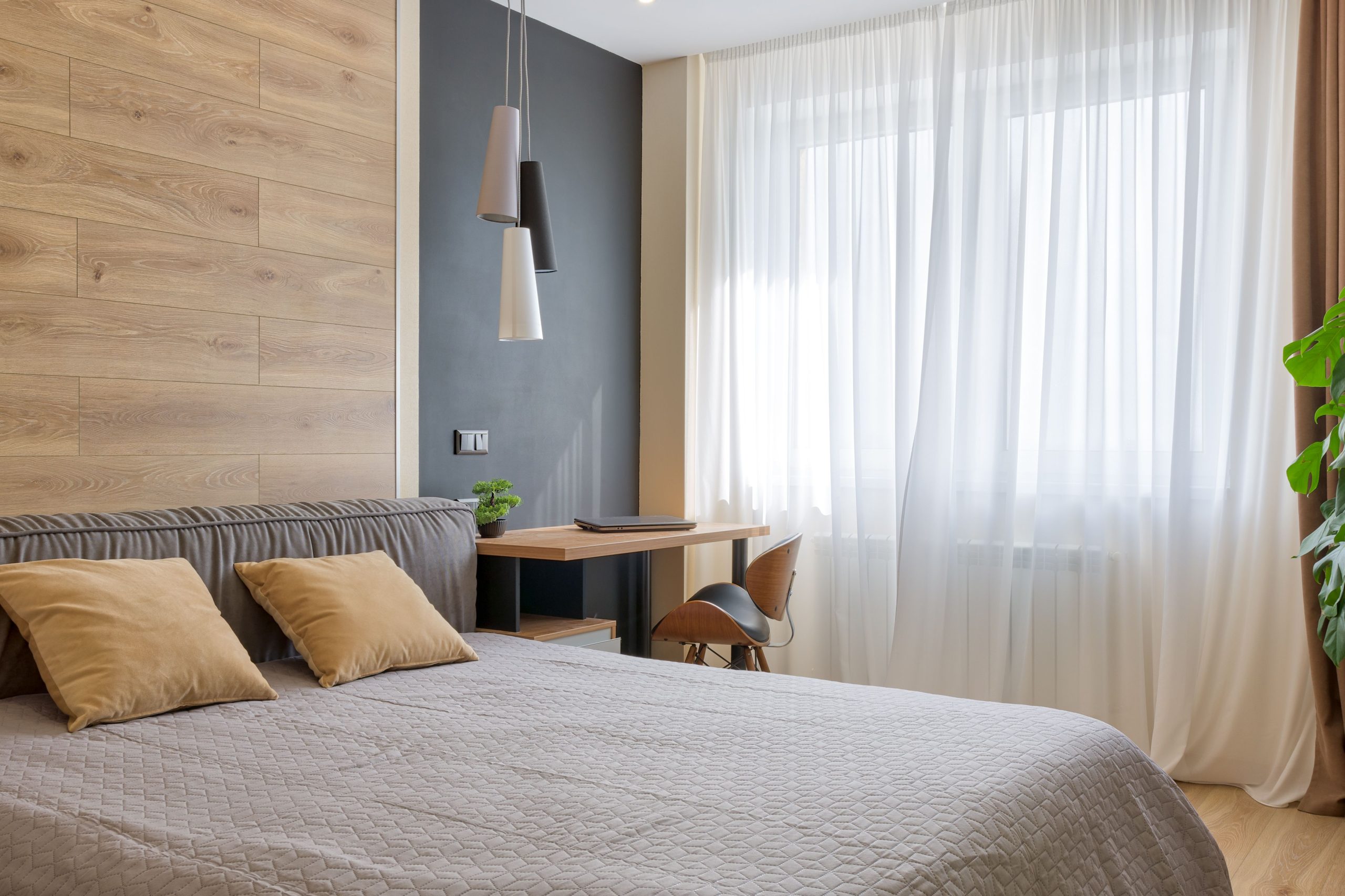 Bright and airy bedroom featuring modern design elements, wooden accents, and natural lighting.
