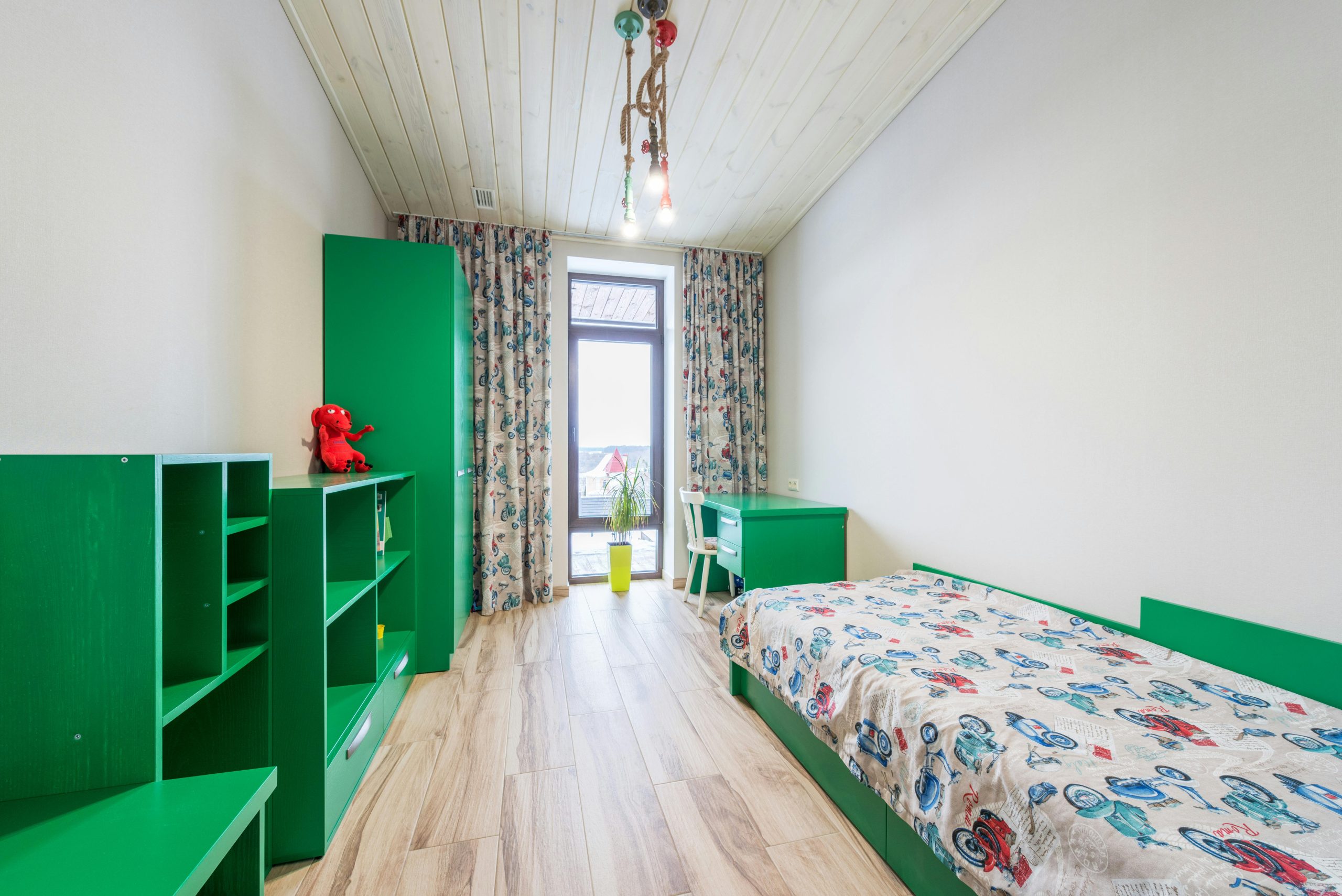 Bright child room with green furniture and playful decor, perfect for a creative space.