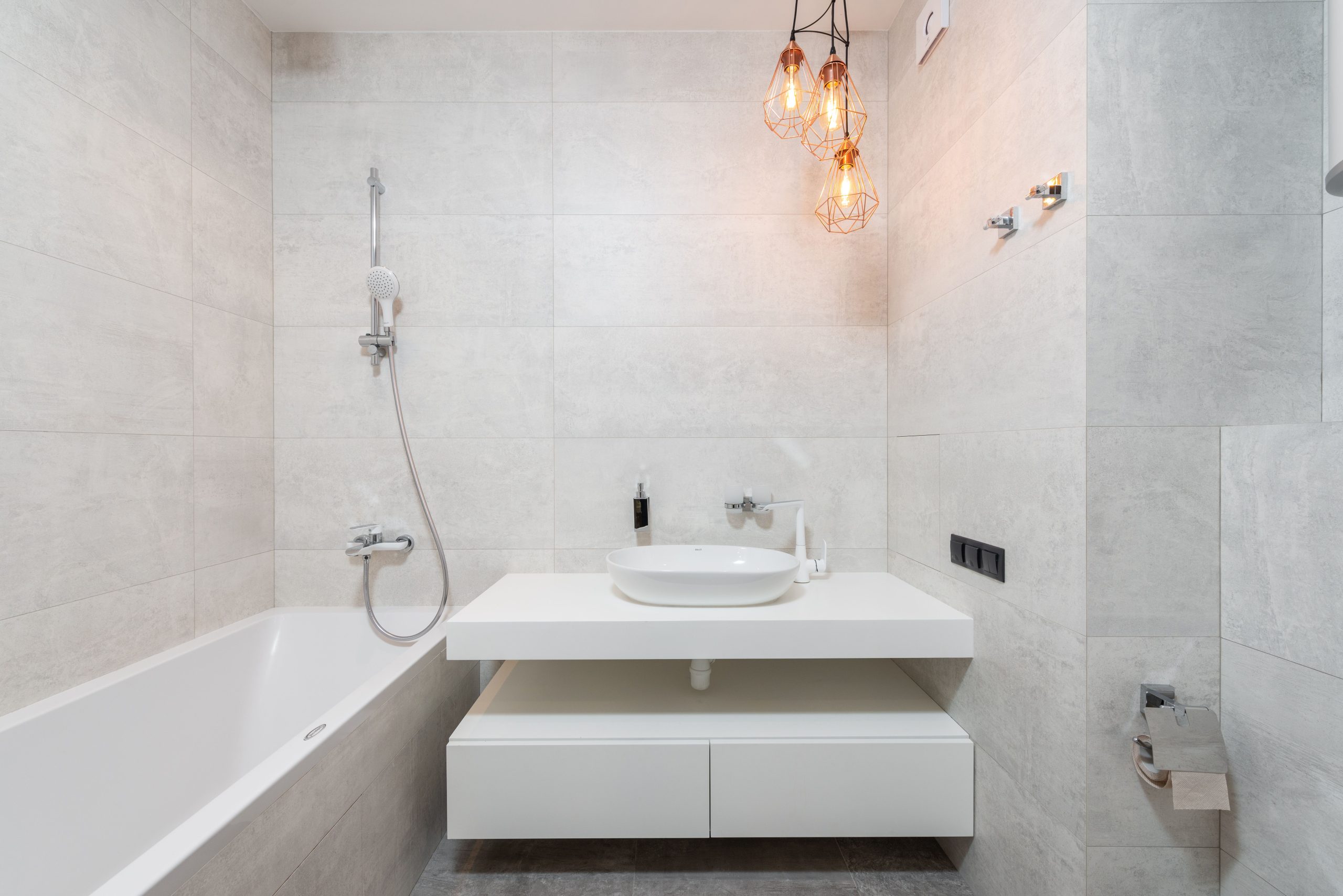 Bright, modern minimalist bathroom with marble tiles and elegant vanity.