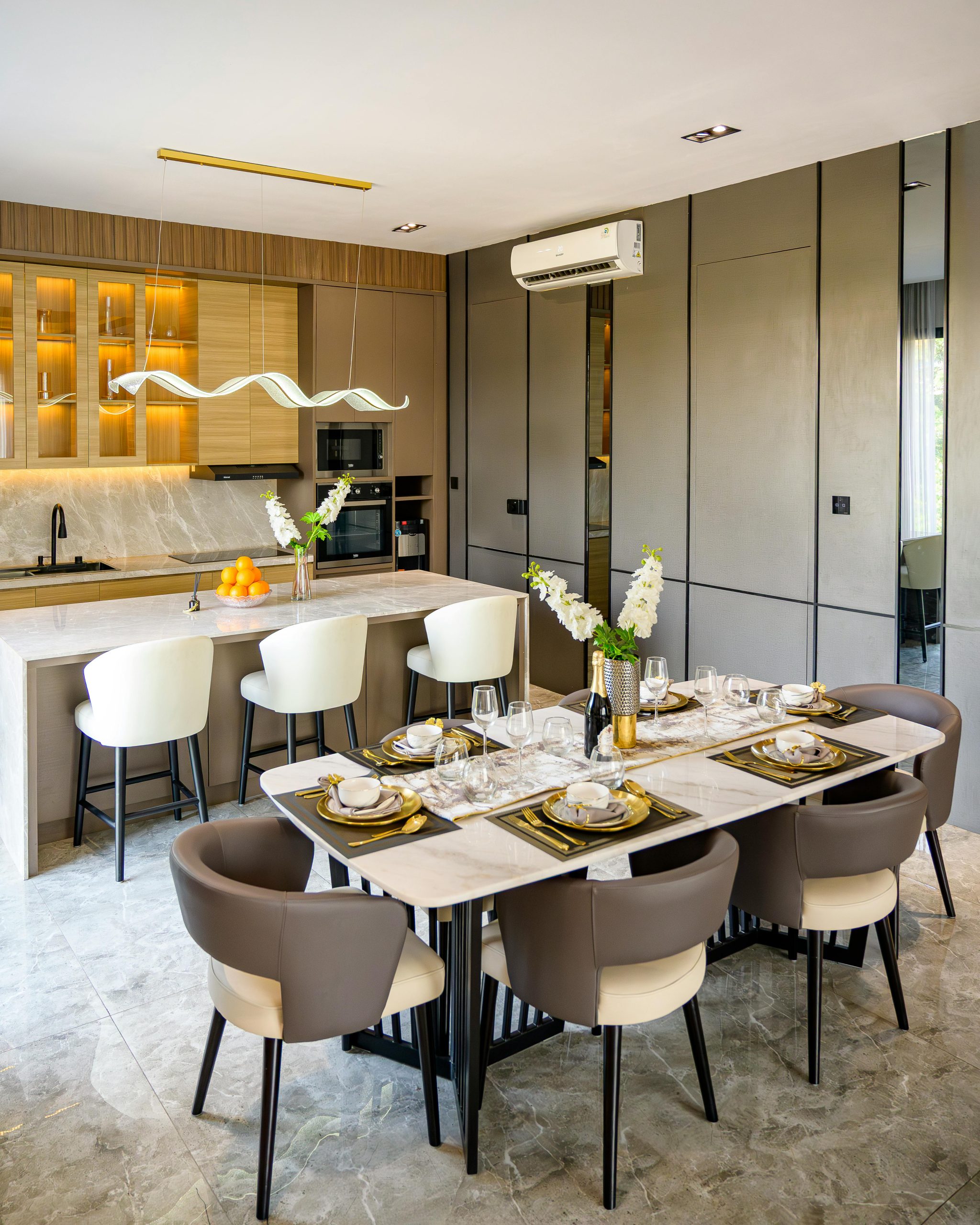 Chic and contemporary dining and kitchen area with elegant decor in Jakarta apartment.