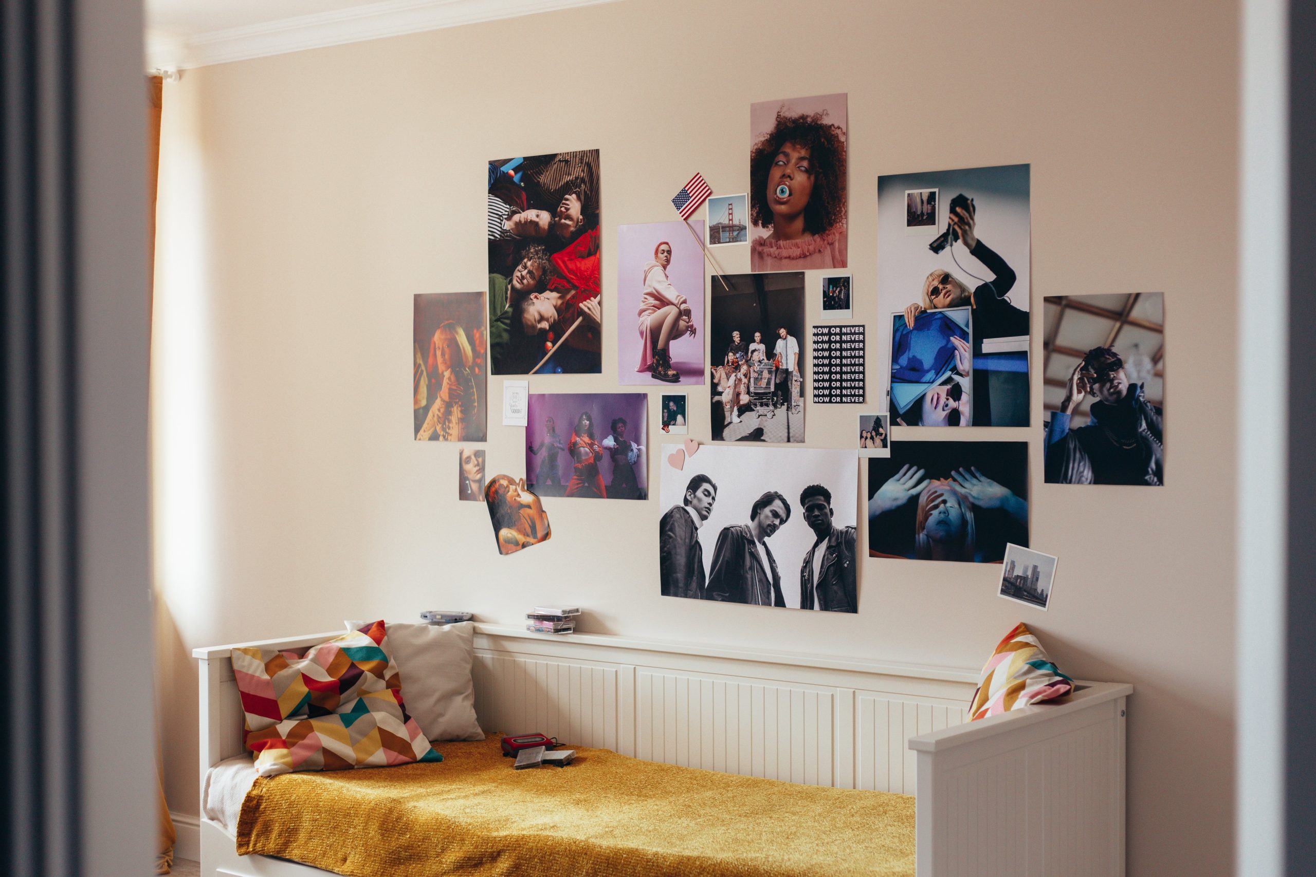 Cozy bedroom featuring a vibrant wall of artistic posters and modern design.