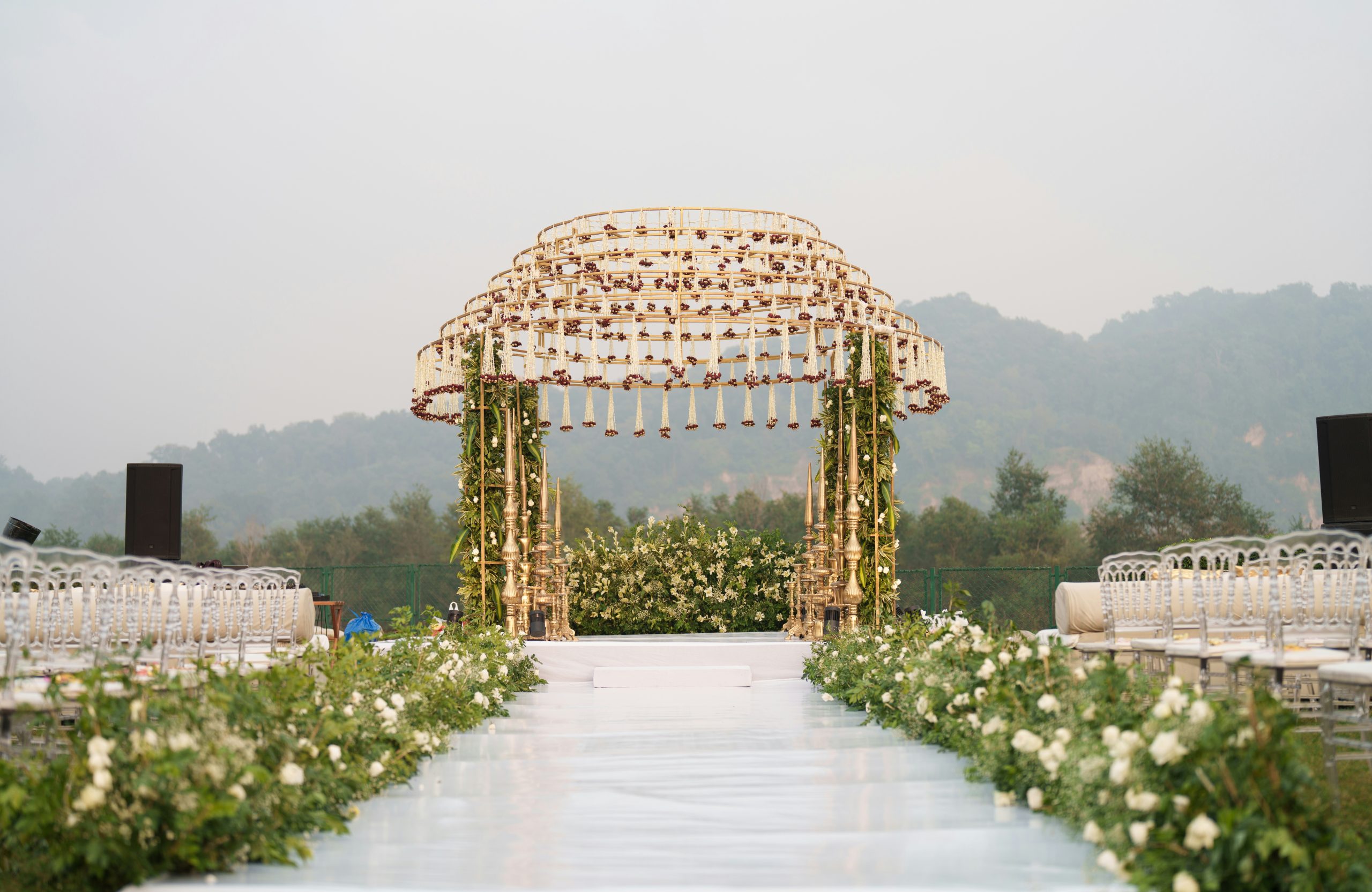 Decorated wedding arch with floral aisle and seating