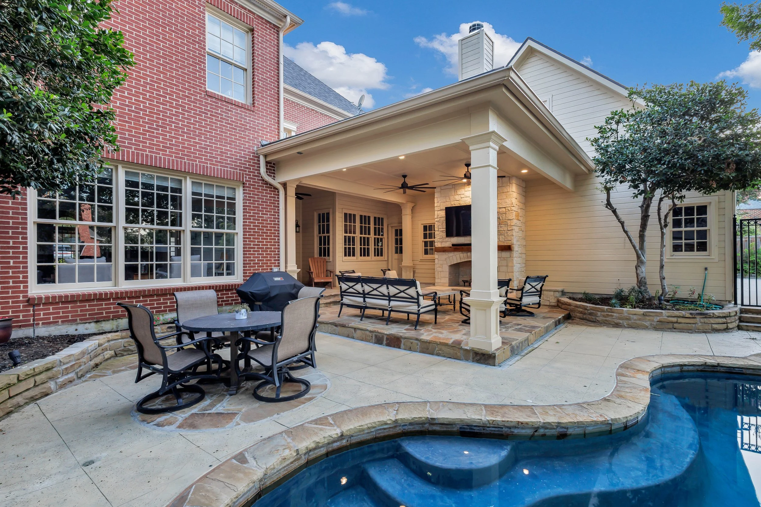 McKinney Patio Cover with Fireplace, Flagstone Pavers & Poolside Hardscapes | Texas Outdoor Living