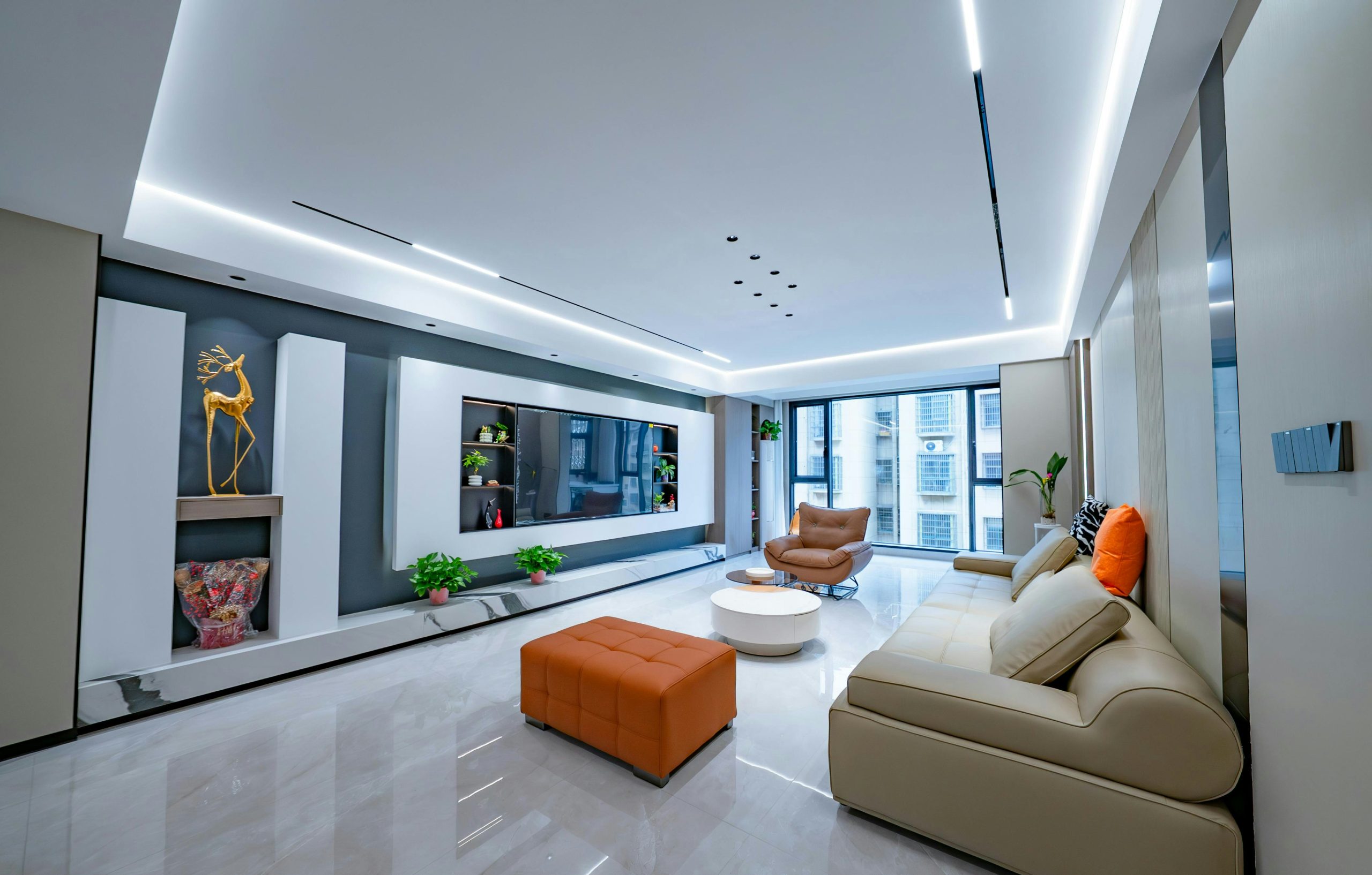 Modern living room with stylish furniture and ambient lighting.