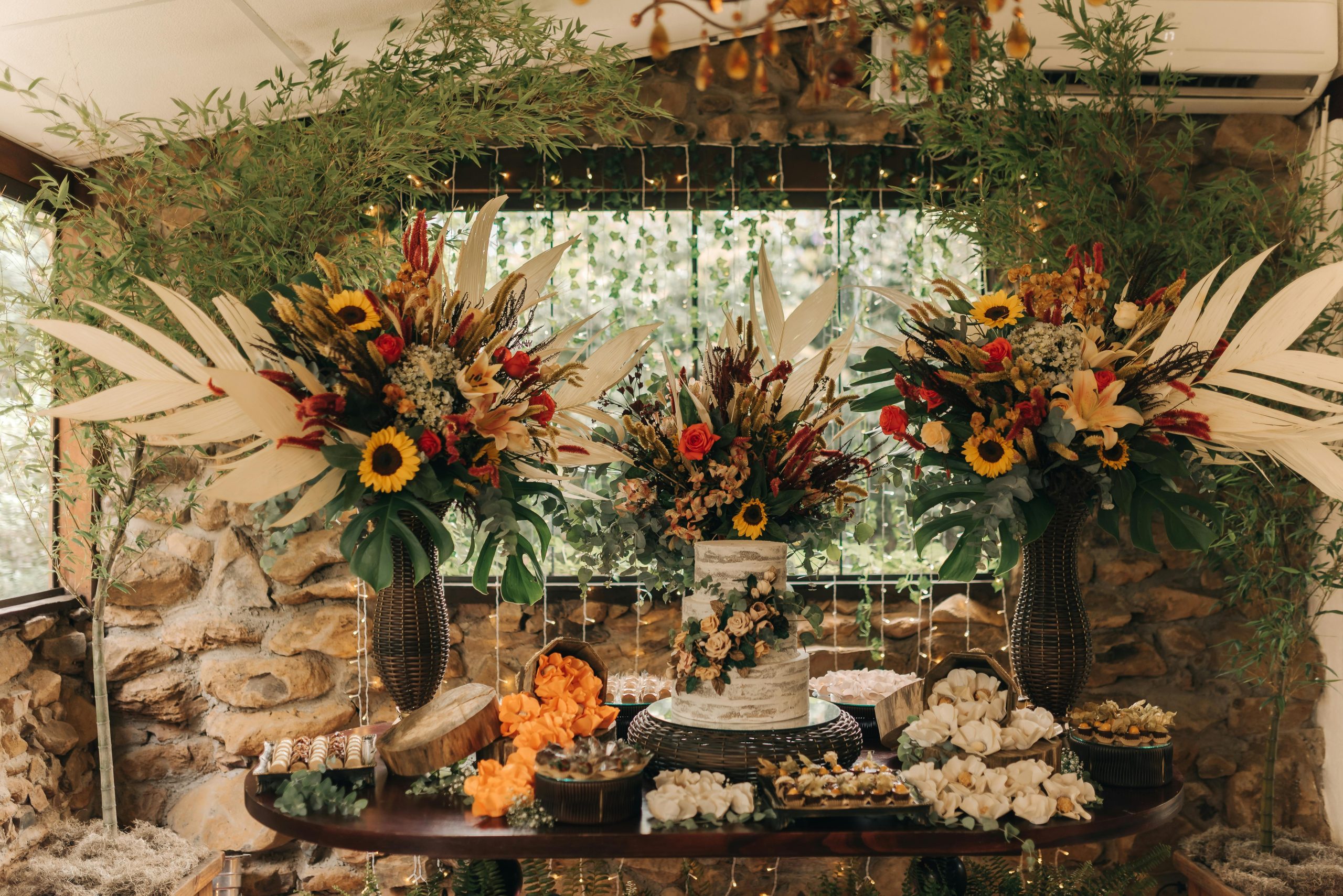 Rustic wedding setup with ornate floral arrangements and decorative cake.