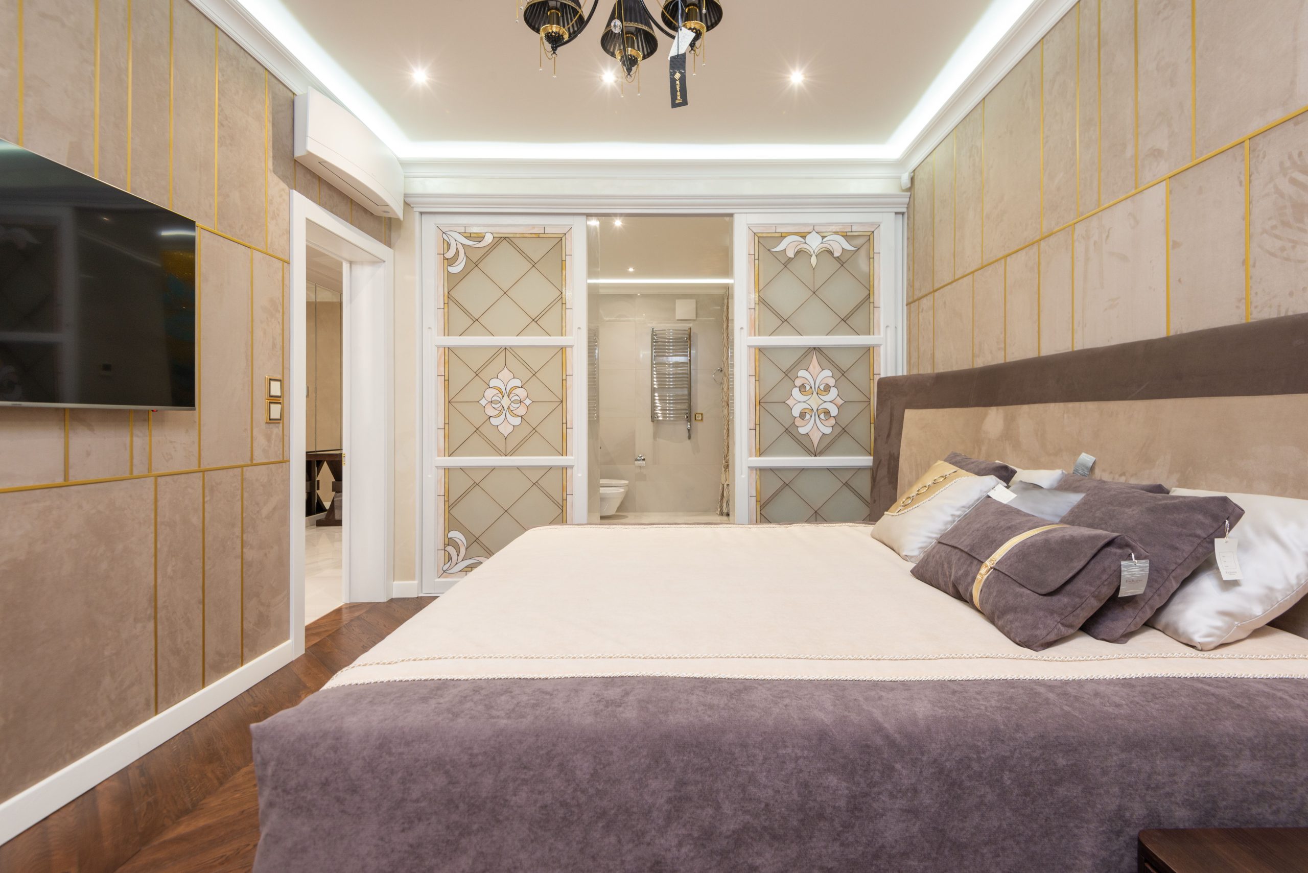 Sophisticated bedroom with modern decor, soft lighting, and luxurious furnishings.