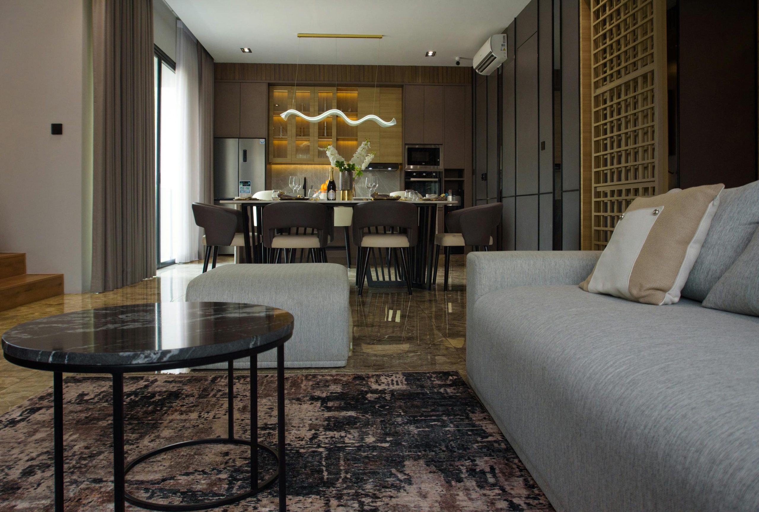 Spacious modern dining and living area with stylish furniture and elegant decor.