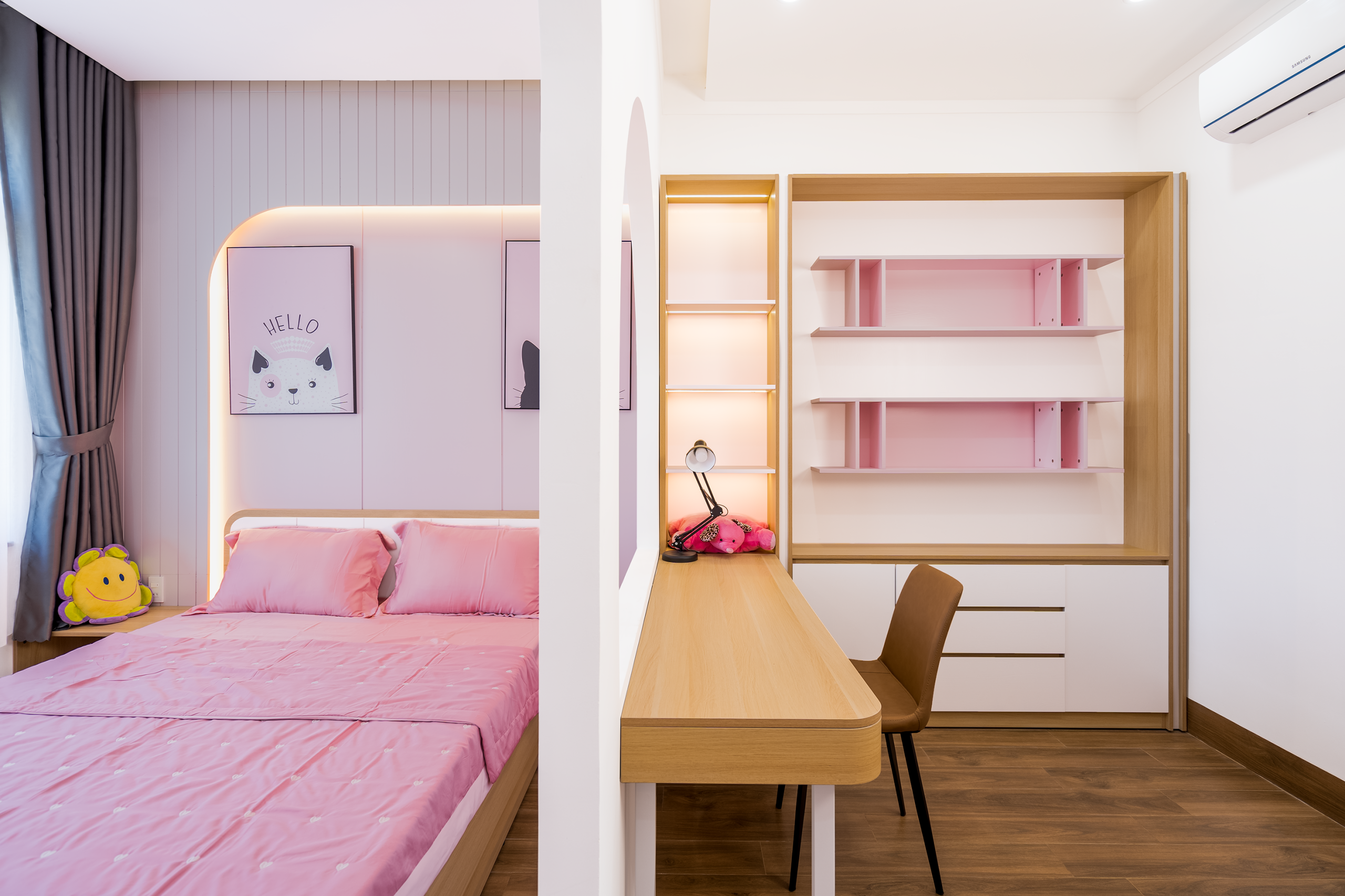 Stylish bedroom featuring pink bedding and a contemporary desk for a fresh interior design.