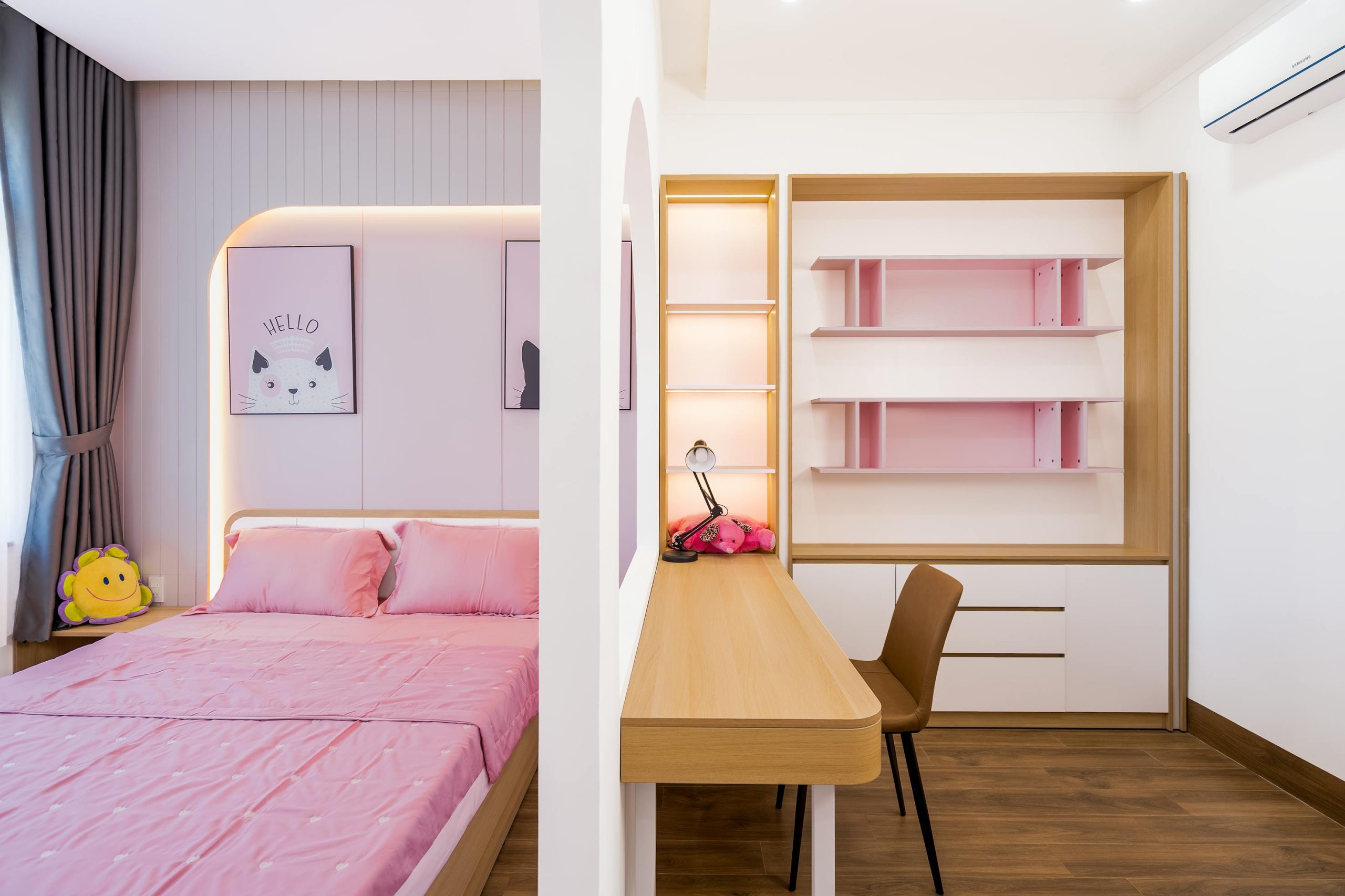 Stylish bedroom featuring pink bedding and a contemporary desk for a fresh interior design.