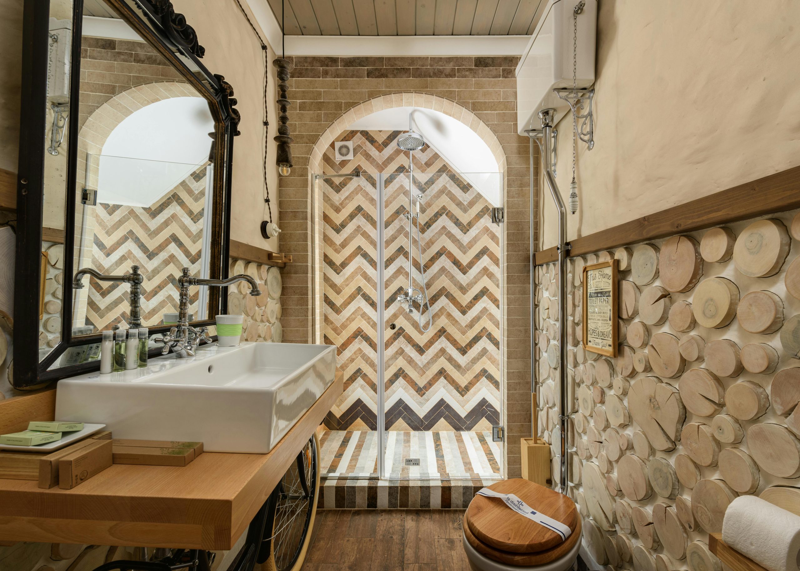 Stylish rustic bathroom featuring a herringbone shower design and natural elements.
