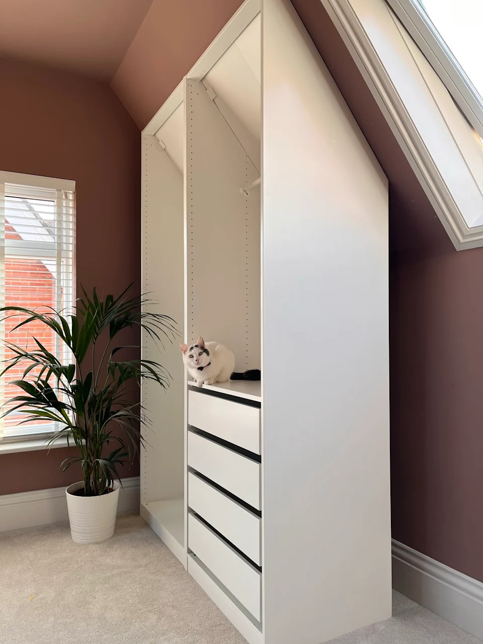 This IKEA PAX hack creates the perfect built-in closet to fit a pitched ceiling – and it's in our favorite Farrow & Ball color