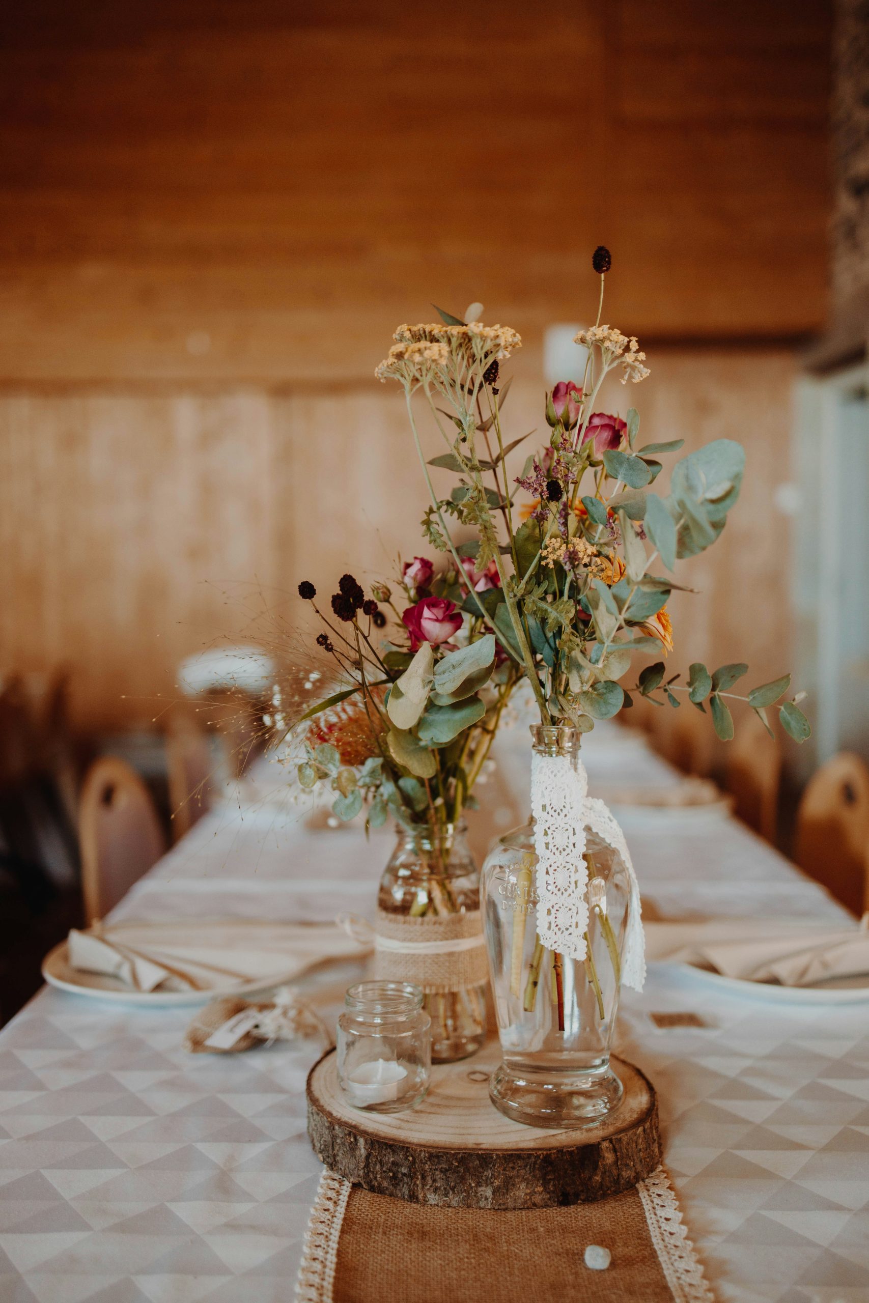 Wildflower arrangements on a rustic wedding table setting
