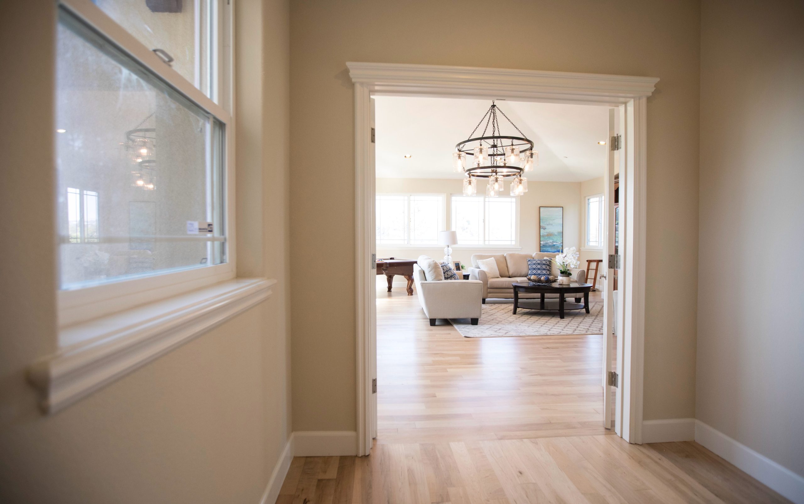 A contemporary living room featuring modern furniture and ample natural light.
