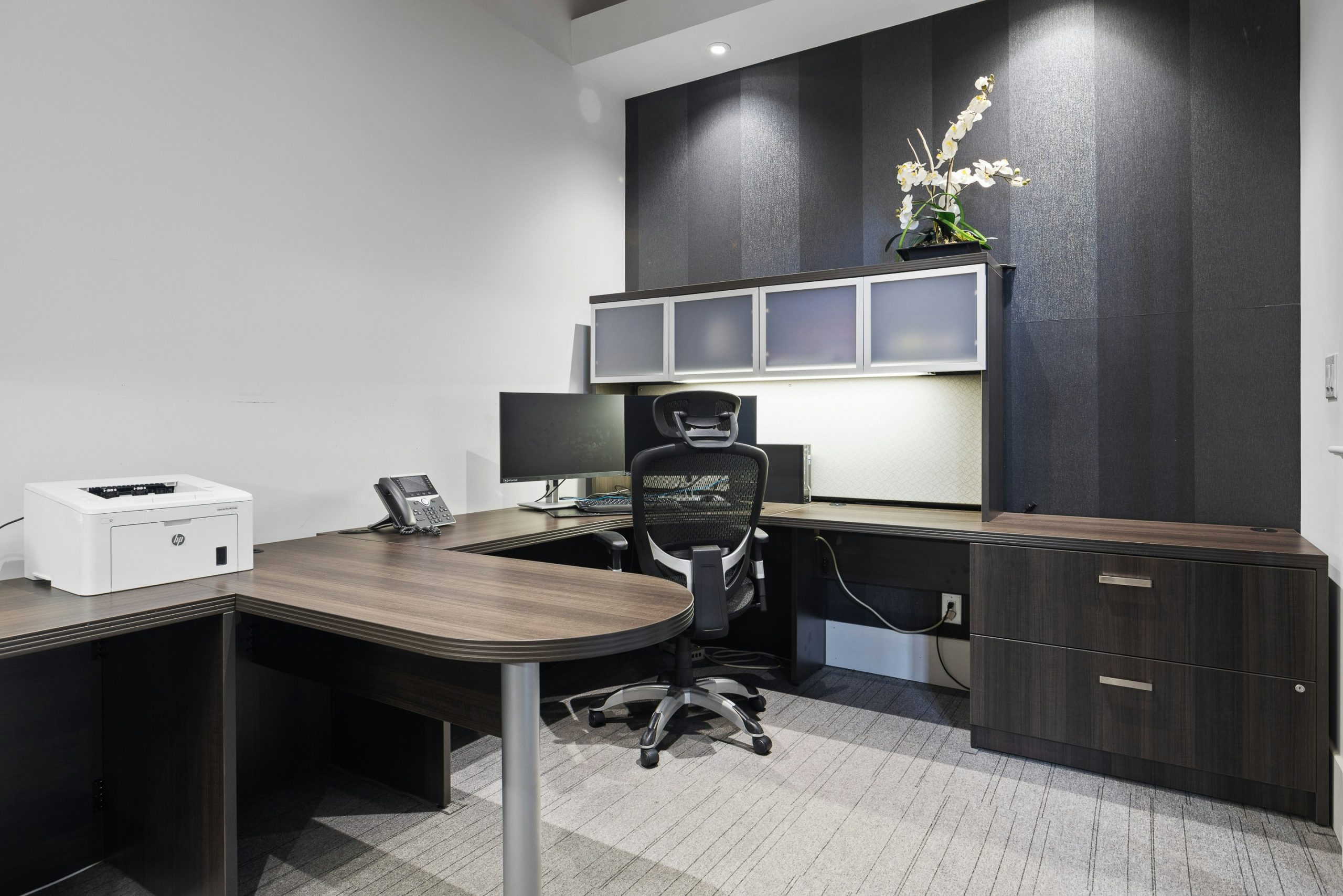 a desk with a chair and a printer on it