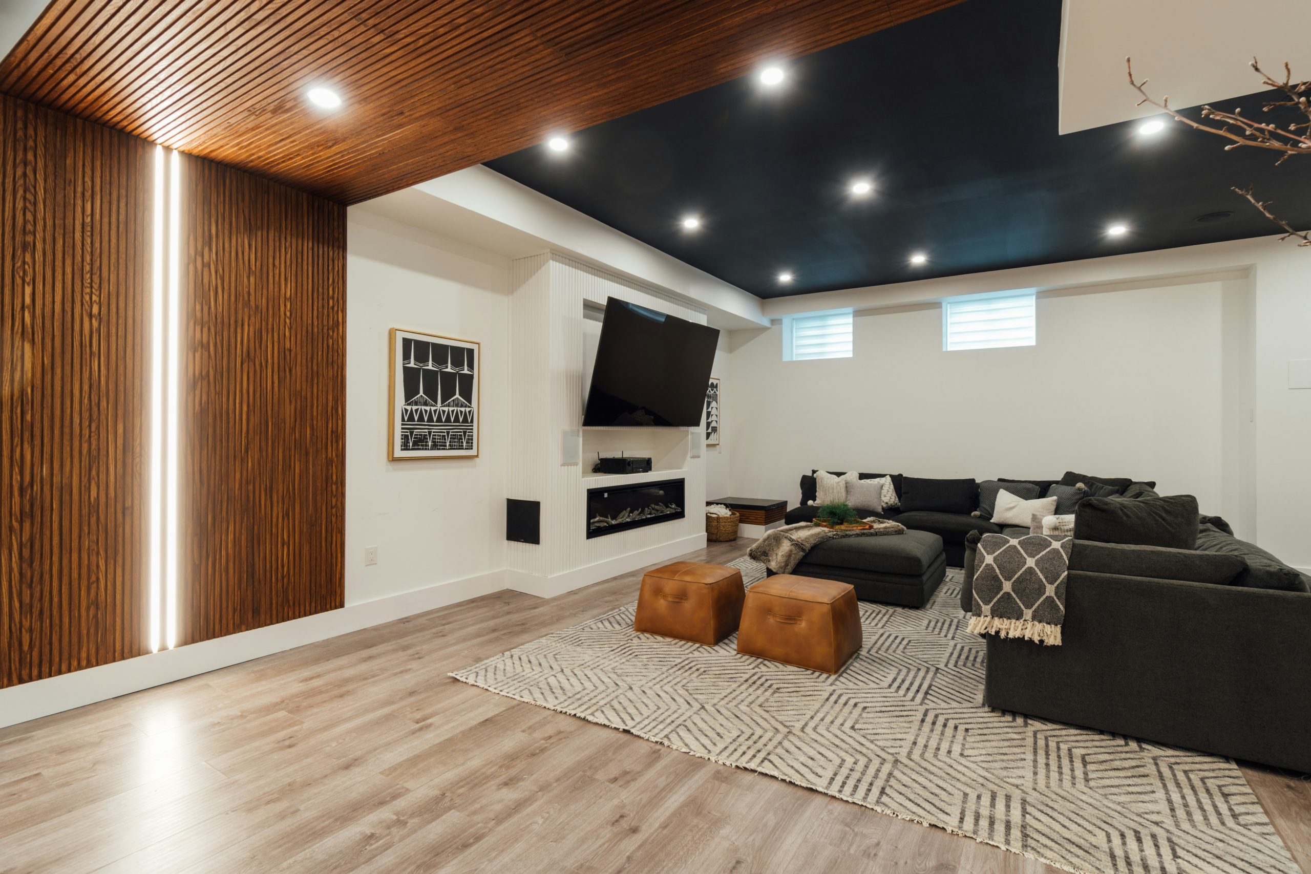 a living room with a couch a chair and a flat screen tv