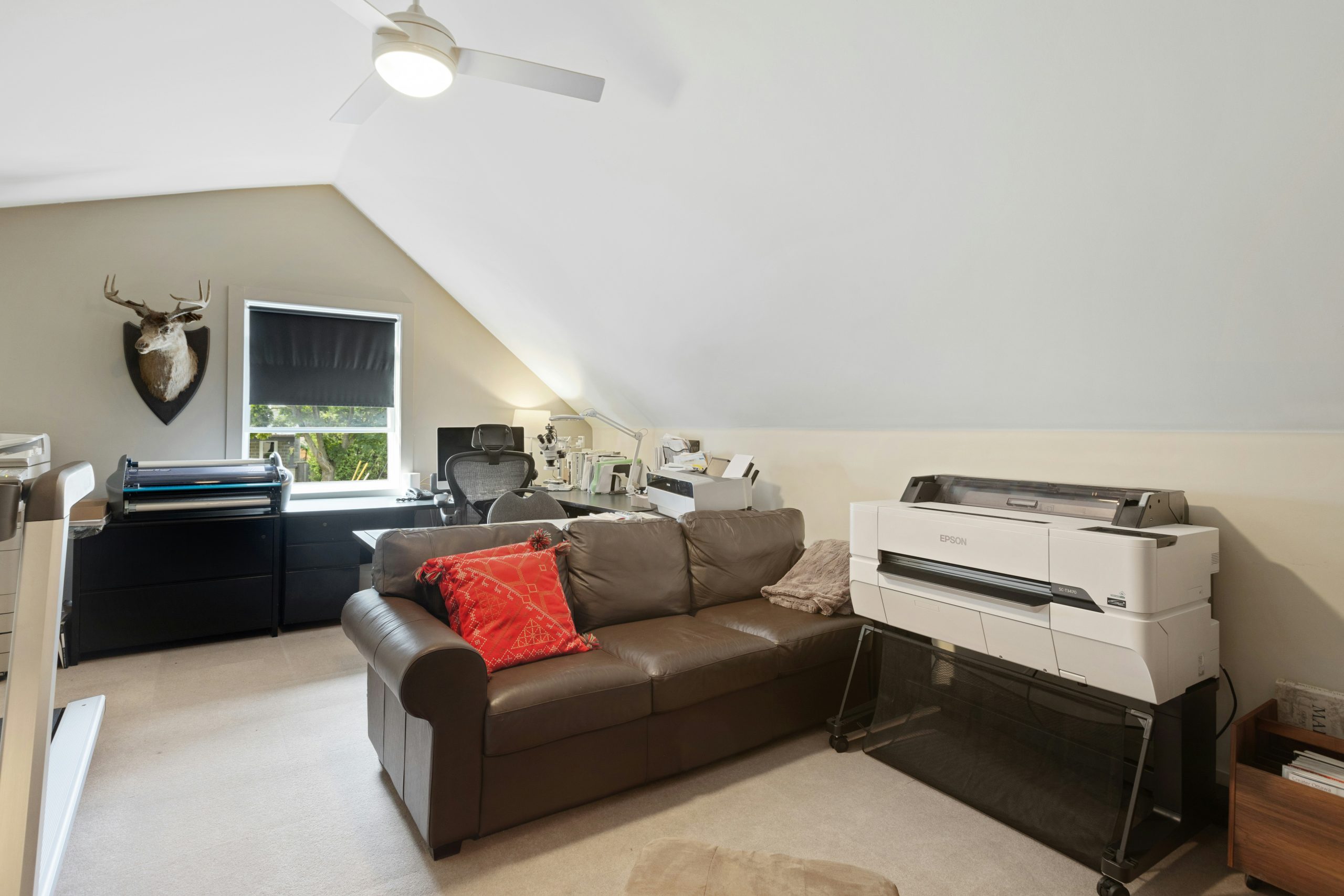 a living room with a couch and a printer