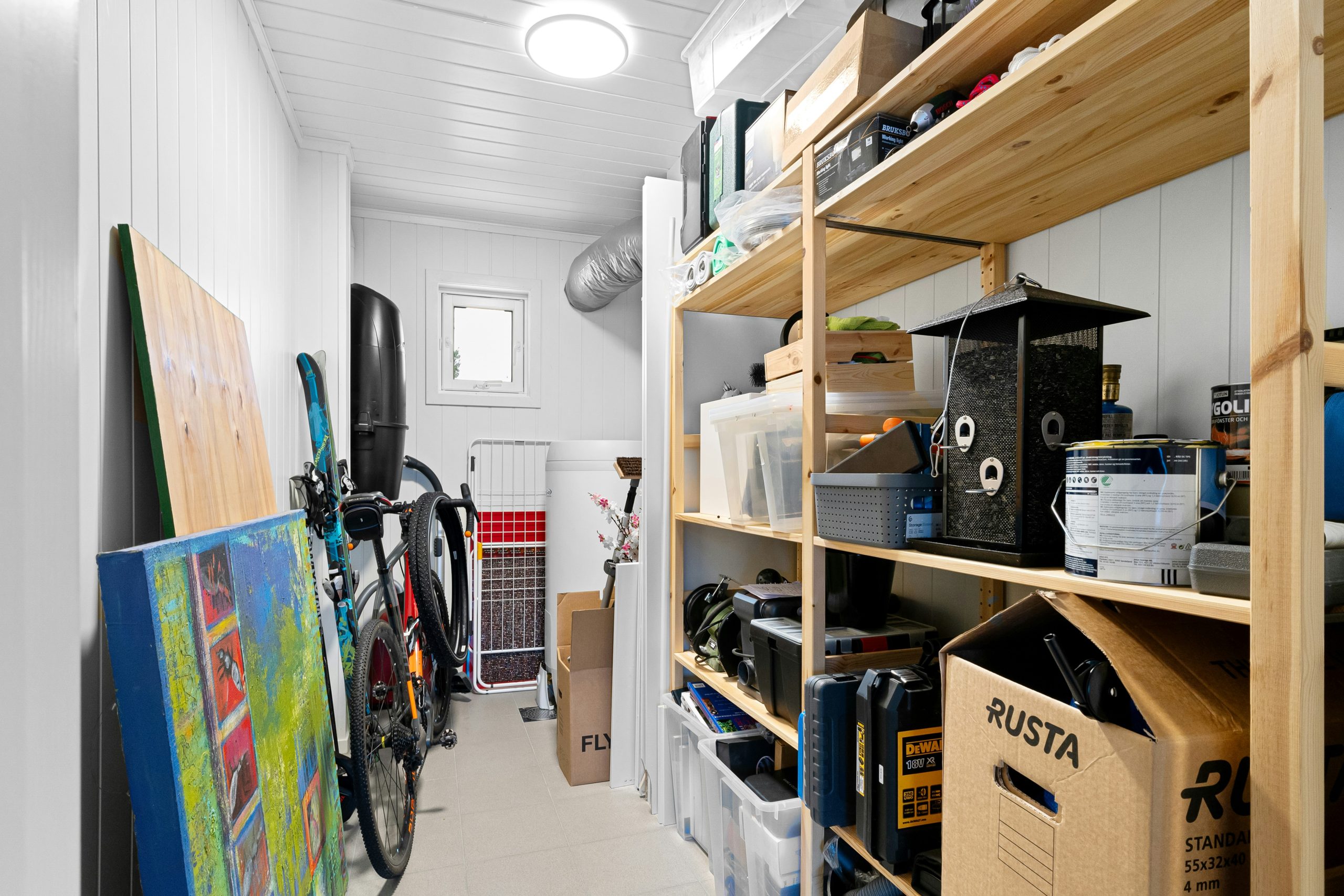 A long narrow room with a lot of storage