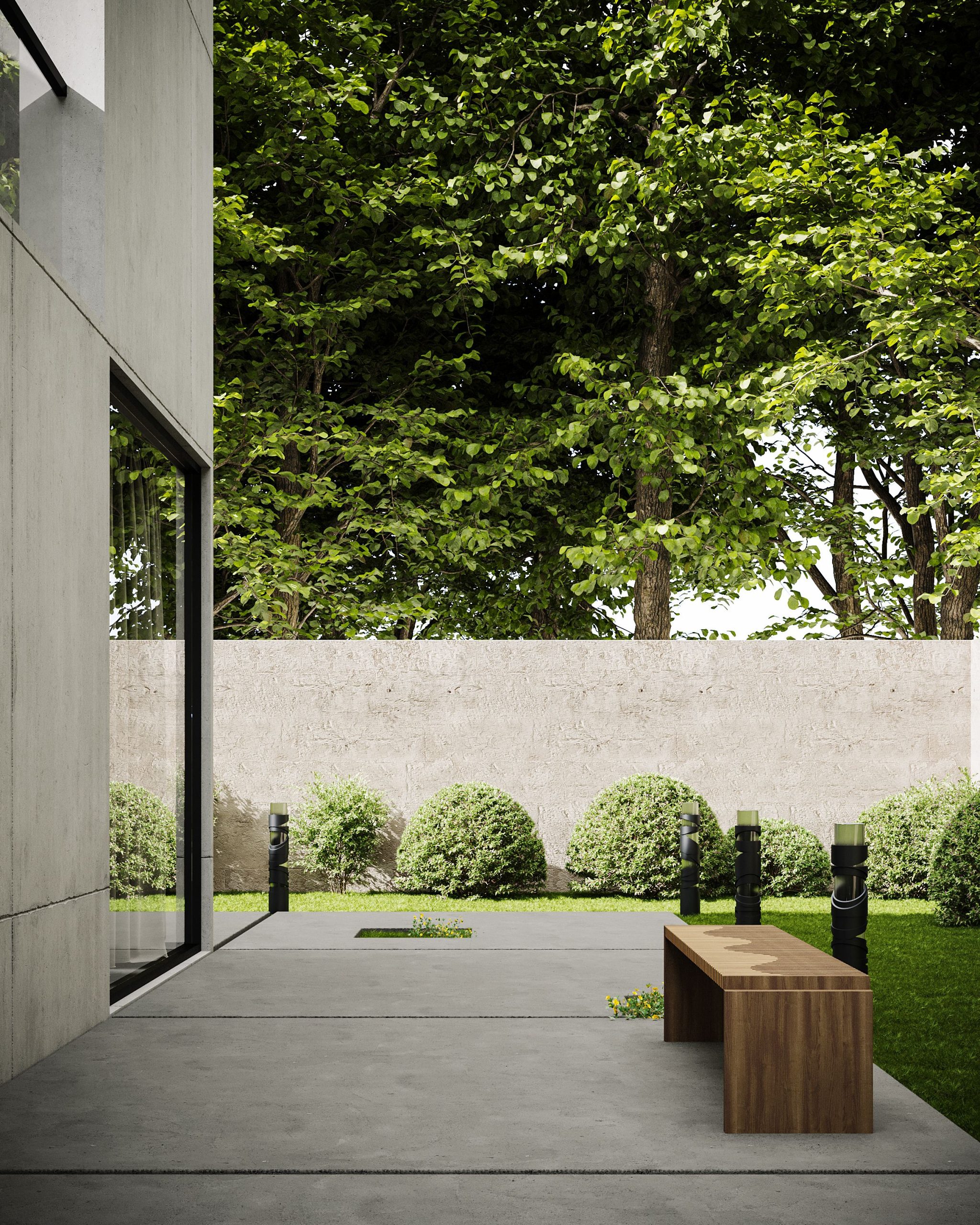 A minimalist outdoor concrete patio with a wooden bench and green garden backdrop.