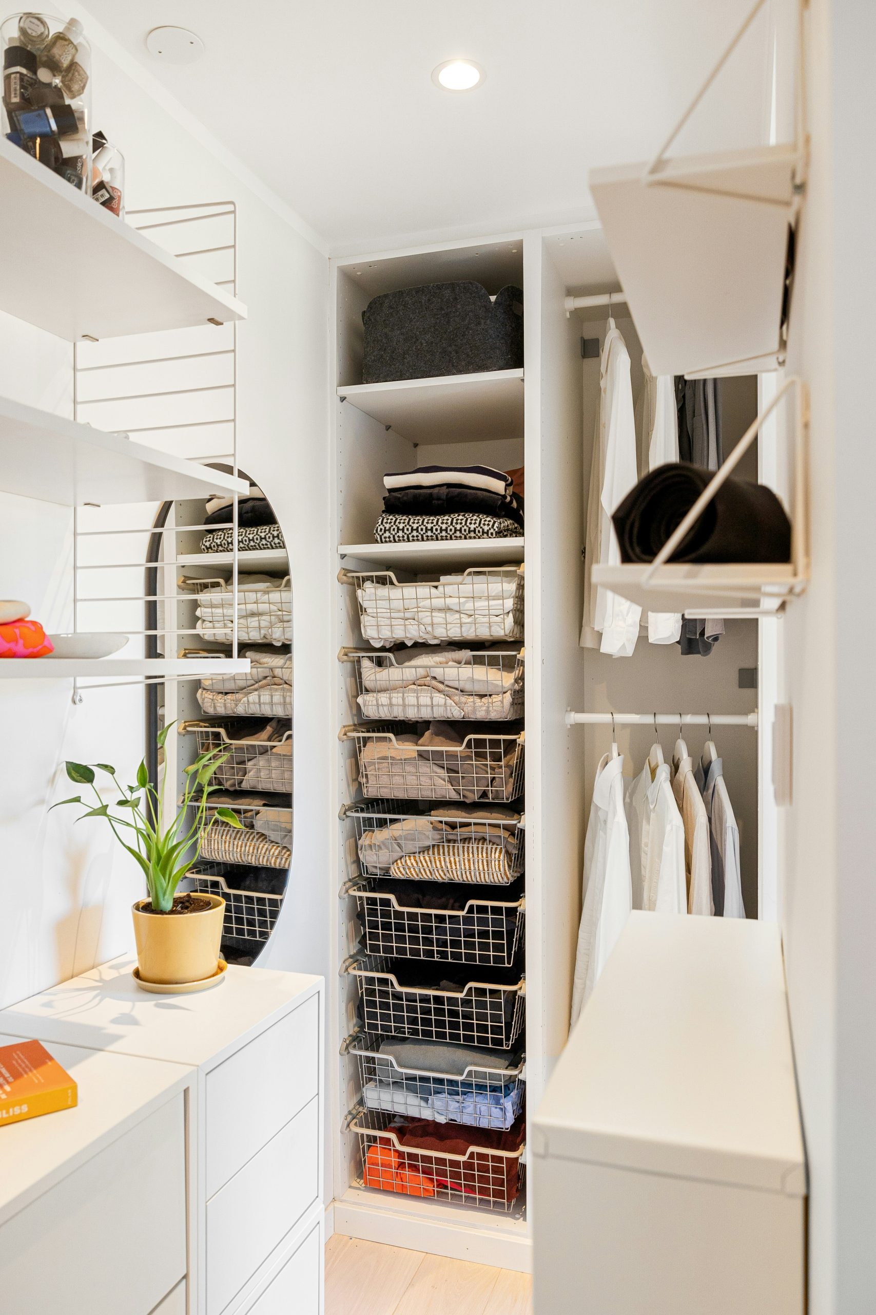 A walk in closet with a lot of clothes