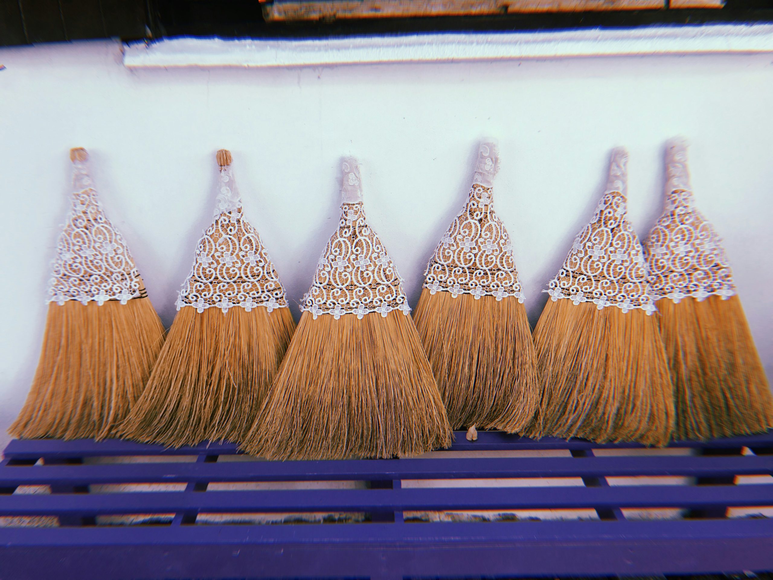 brown and silver broom on black steel fence