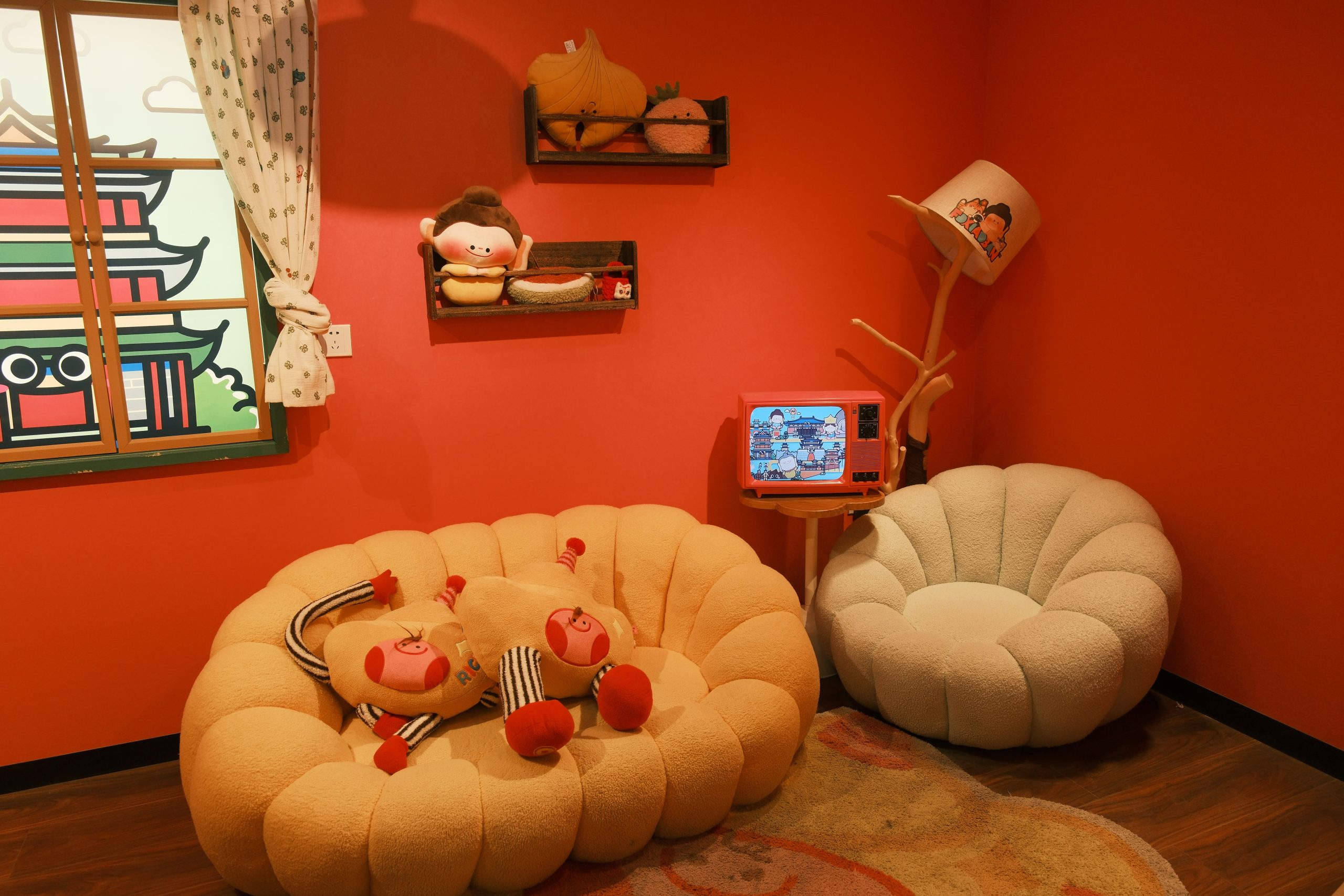 Cozy room with plush toys and beanbag chairs.